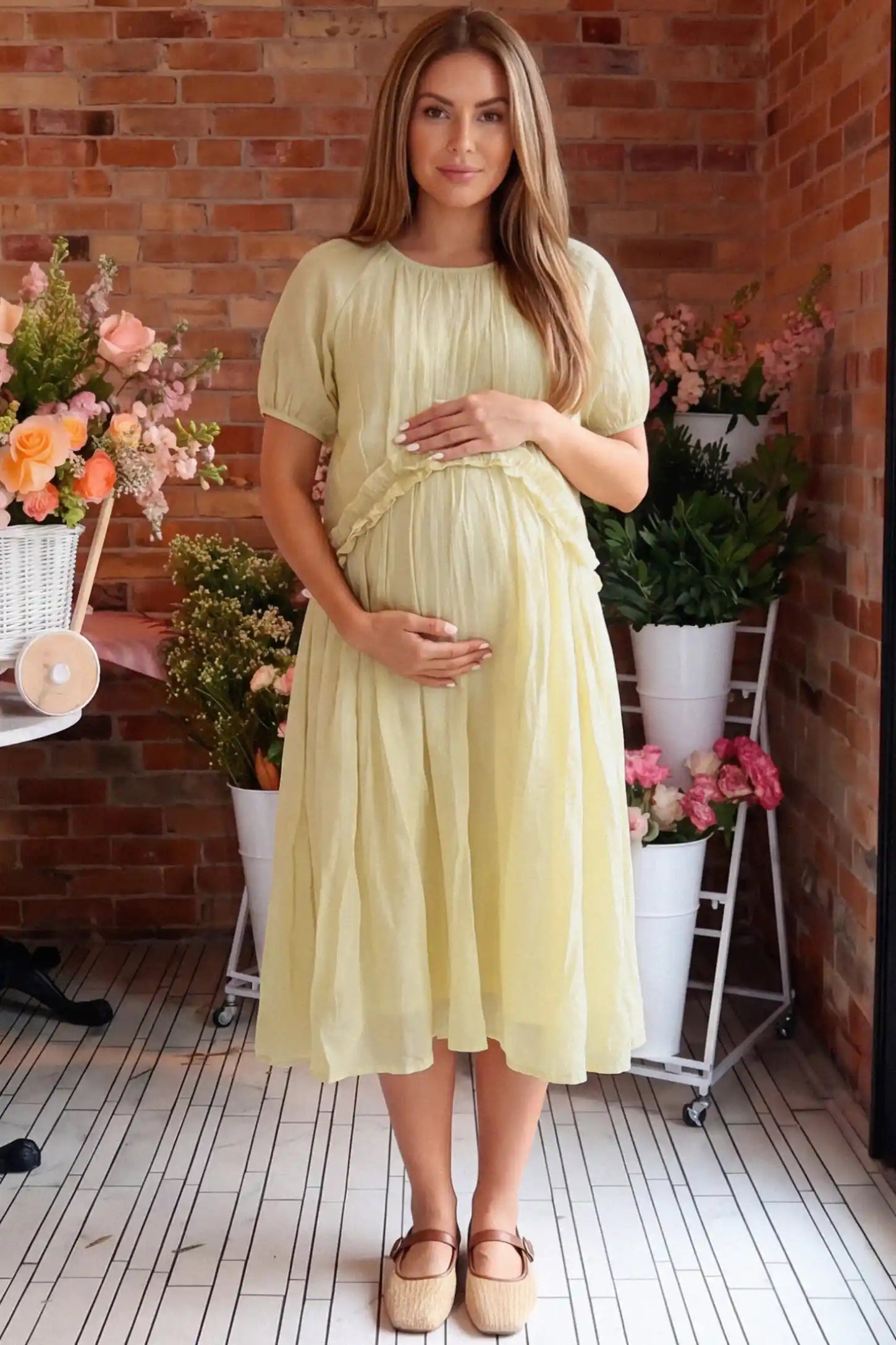 Round Neck Short Sleeve Flowy Maternity Midi Dress Round Neck Short Sleeve Flowy Maternity Midi Dress in Yellow featuring ruffled waist on a pregnant woman in indoor setting, front view.