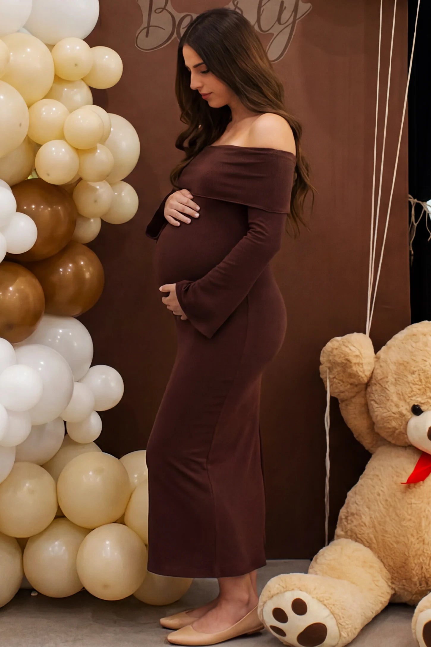 Ruched Off-shoulder Bodycon Maternity Midi Dress in Coffee with a sophisticated ruched design, lifestyle side view on a pregnant model.