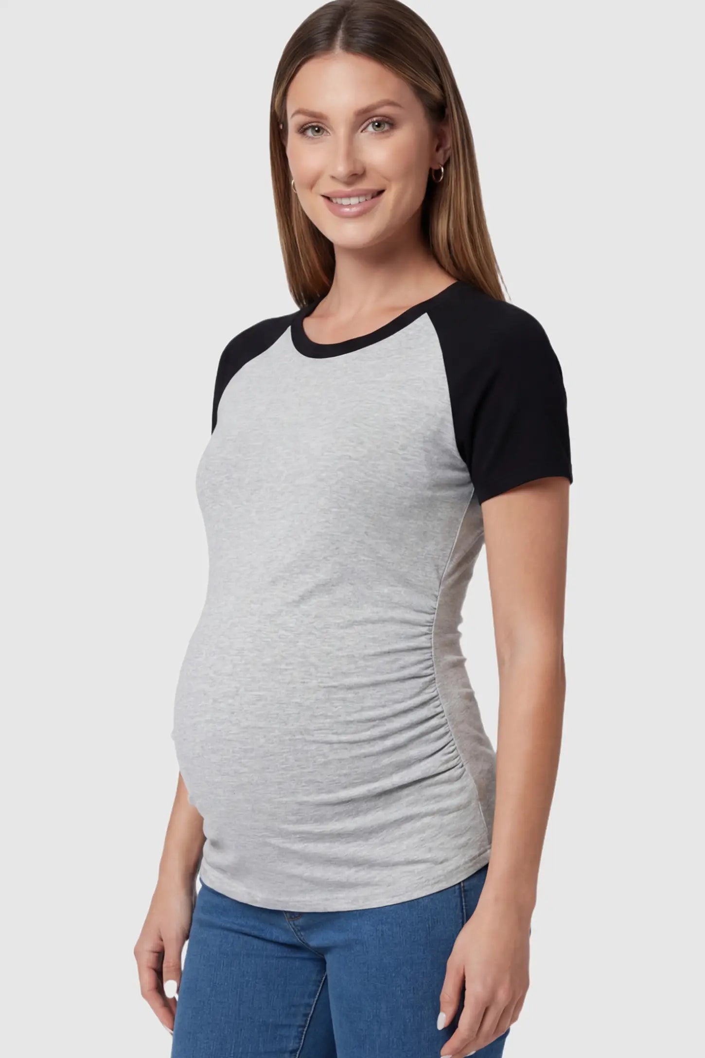 Ruched Raglan Short Sleeve Maternity T-Shirt Ruched Raglan Short Sleeve Maternity Top in Gray and Black featuring side-seam gathering on a pregnant model showing side.