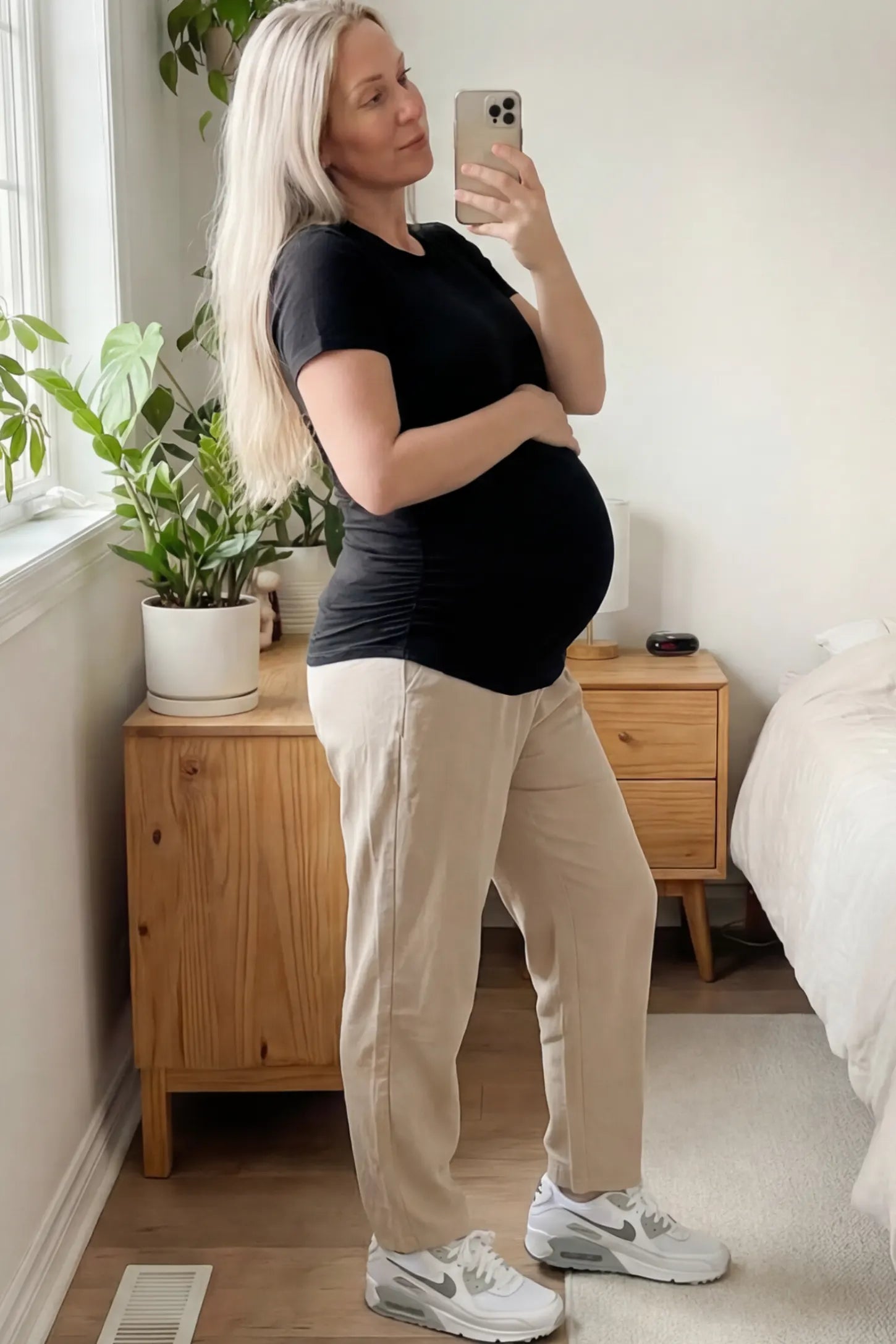 Ruched Side Short Sleeve Maternity T-Shirt Ruched Side Short Sleeve Maternity Basic Tee in Black featuring a classic crew neck on a pregnant woman.