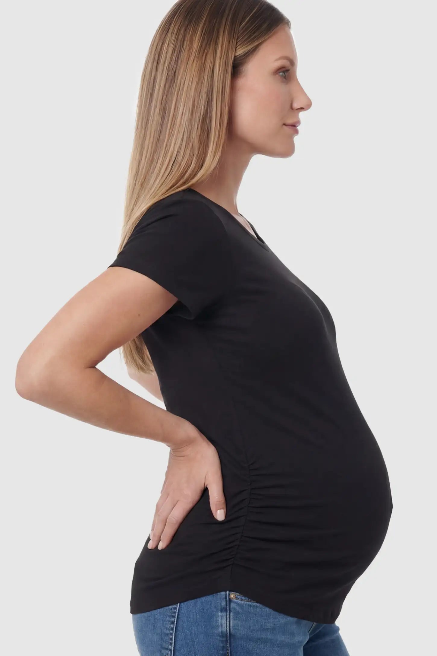 Ruched Side Short Sleeve Maternity T-Shirt Ruched Side Short Sleeve Maternity Basic Tee in Black featuring a classic crew neck on a pregnant model showing side.