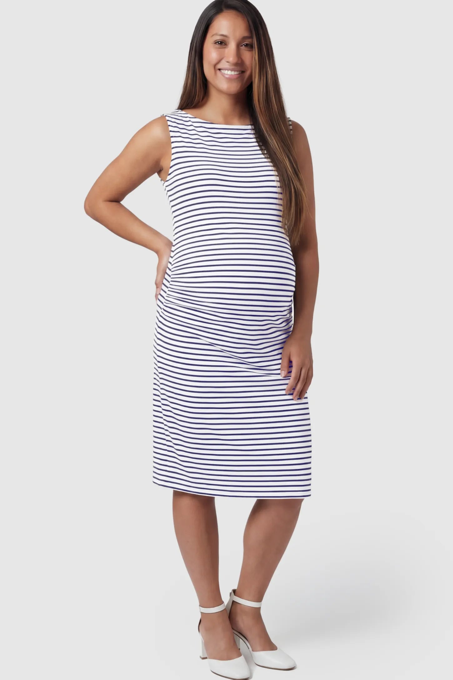 Ruched Sleeveless Bodycon Maternity Midi Dress Ruched Sleeveless Bodycon Maternity Midi Dress in Black white stripe pattern featuring side-seam gathering on a pregnant model showing front.