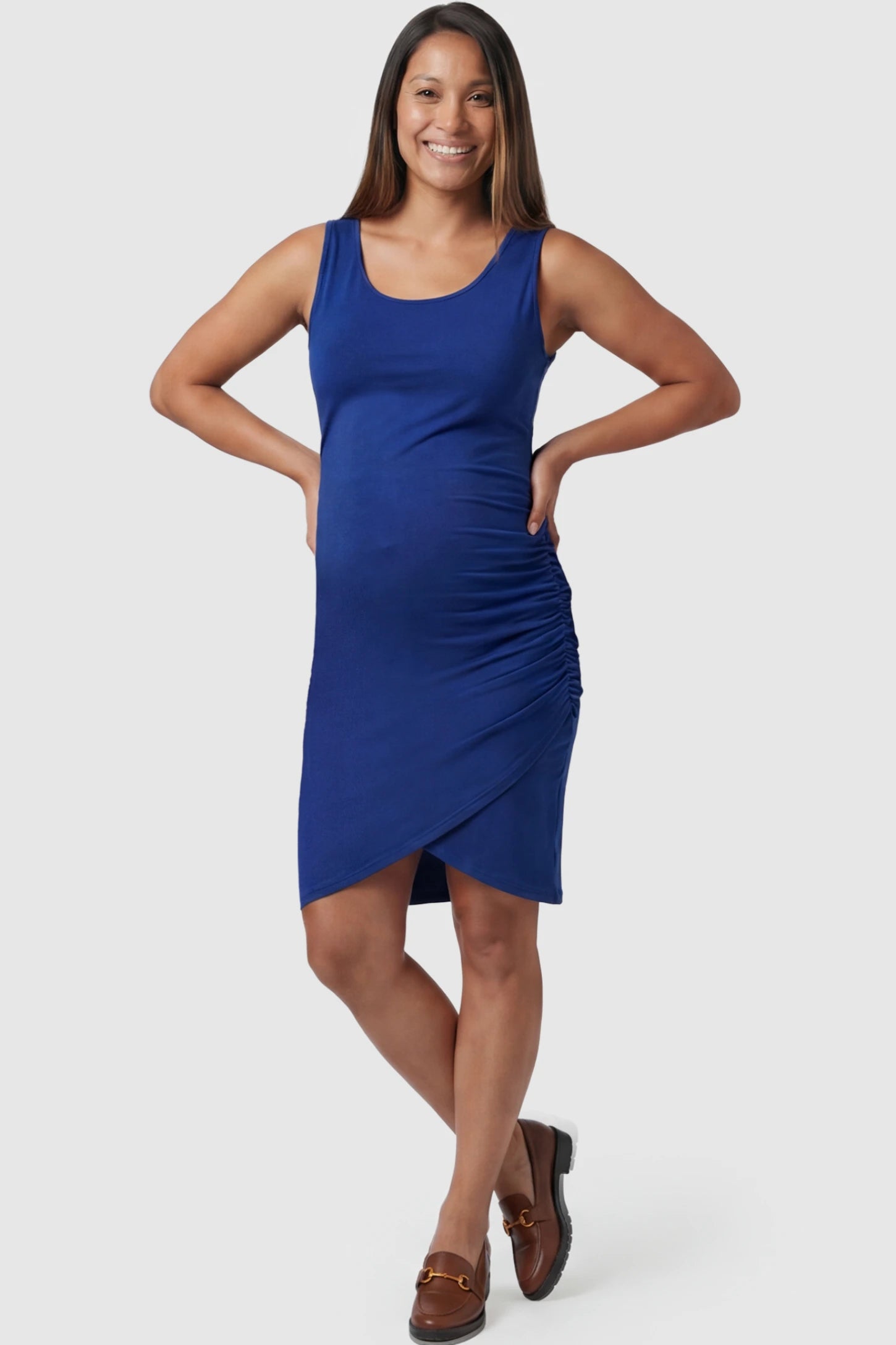 Ruched Tulip-Hem Bodycon Maternity Dress in Navy Blue featuring a side-ruched pencil skirt on a pregnant model posing front.