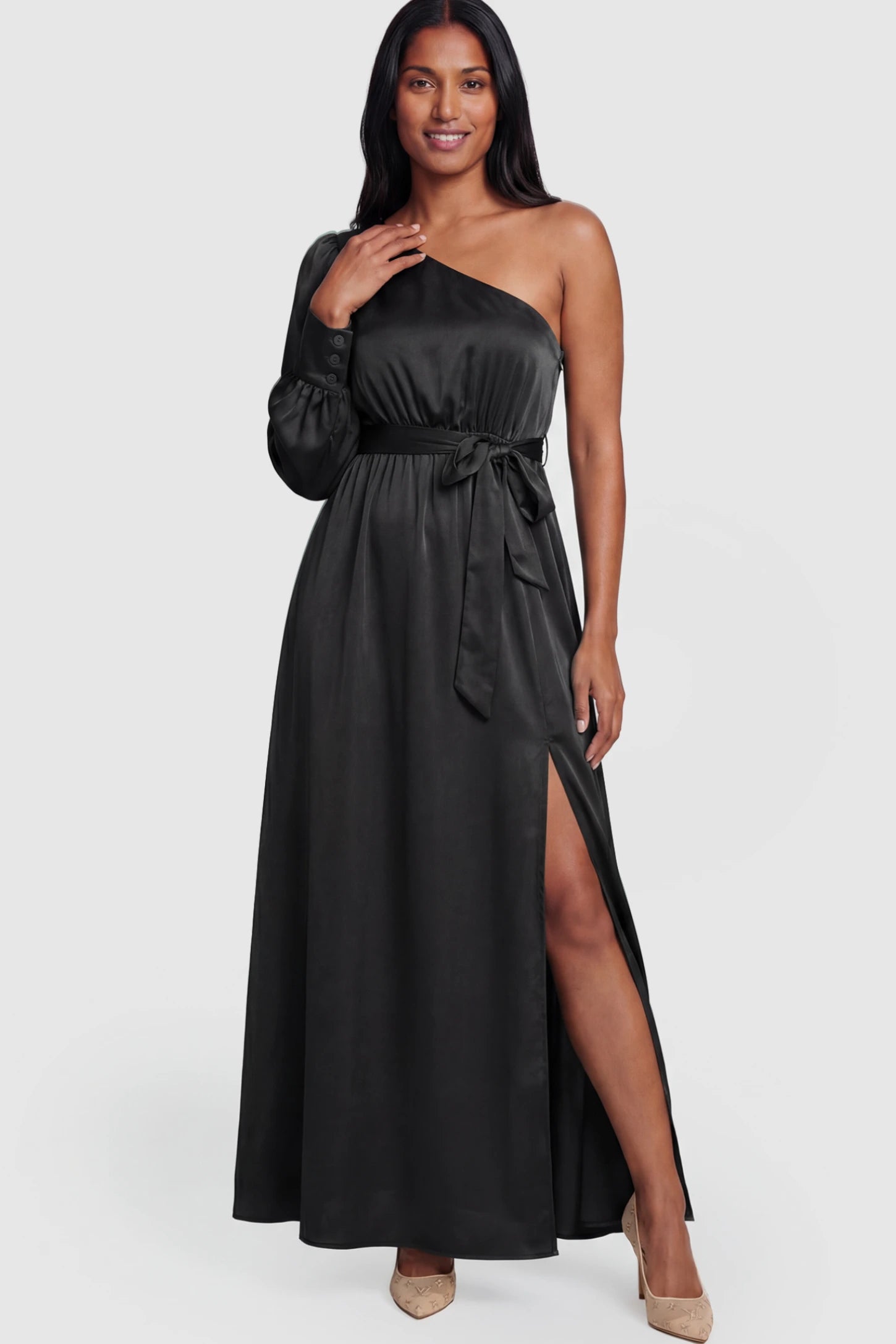 Satin One Shoulder Belted Maternity Maxi Dress Satin One-Shoulder Belted Maternity Maxi Dress in Black featuring a side slit and waist tie on a postpartum model.