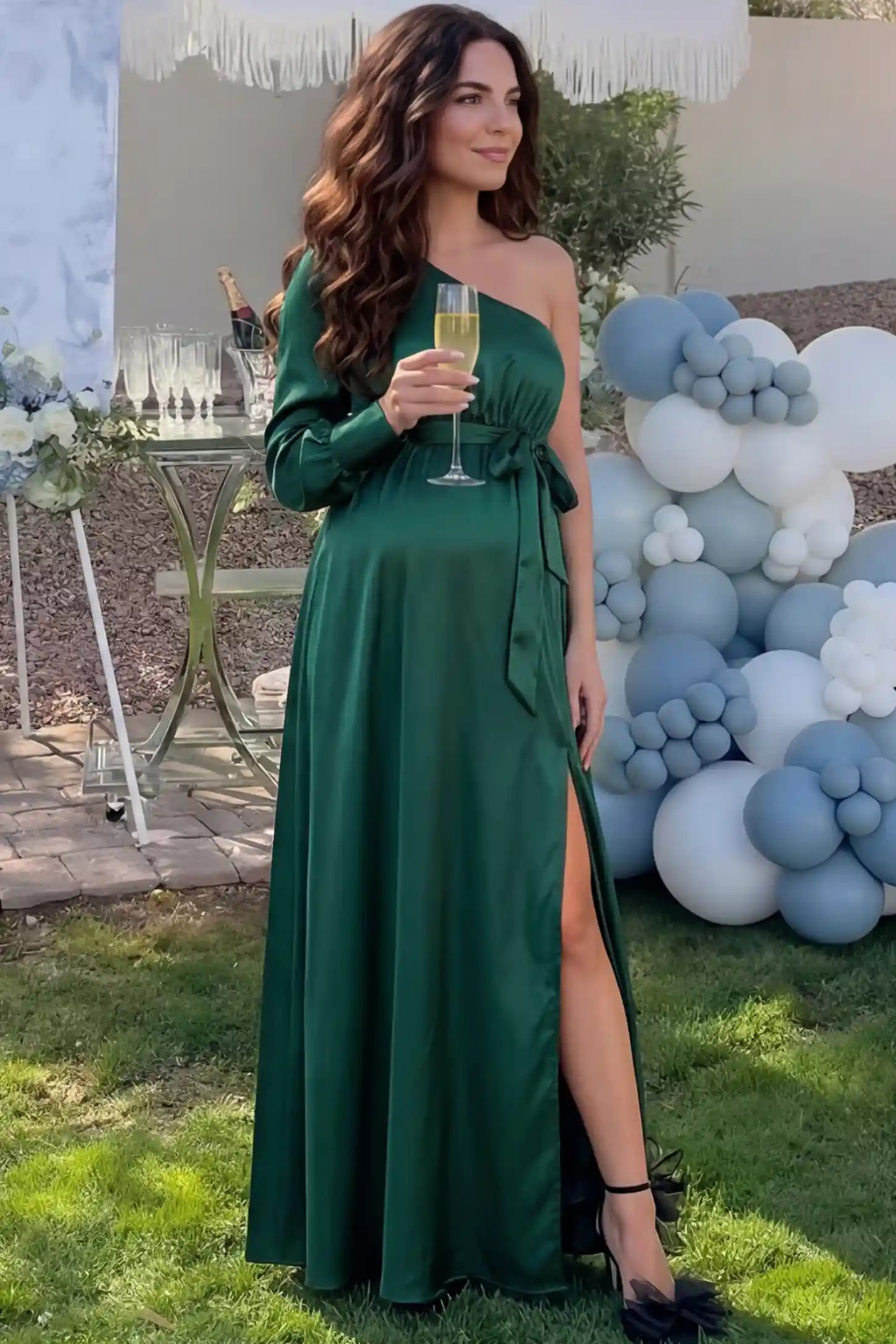 Satin One-Shoulder Belted Maternity Maxi Dress in Green featuring a side slit and waist tie on a pregnant woman during outdoor photoshoot front view.