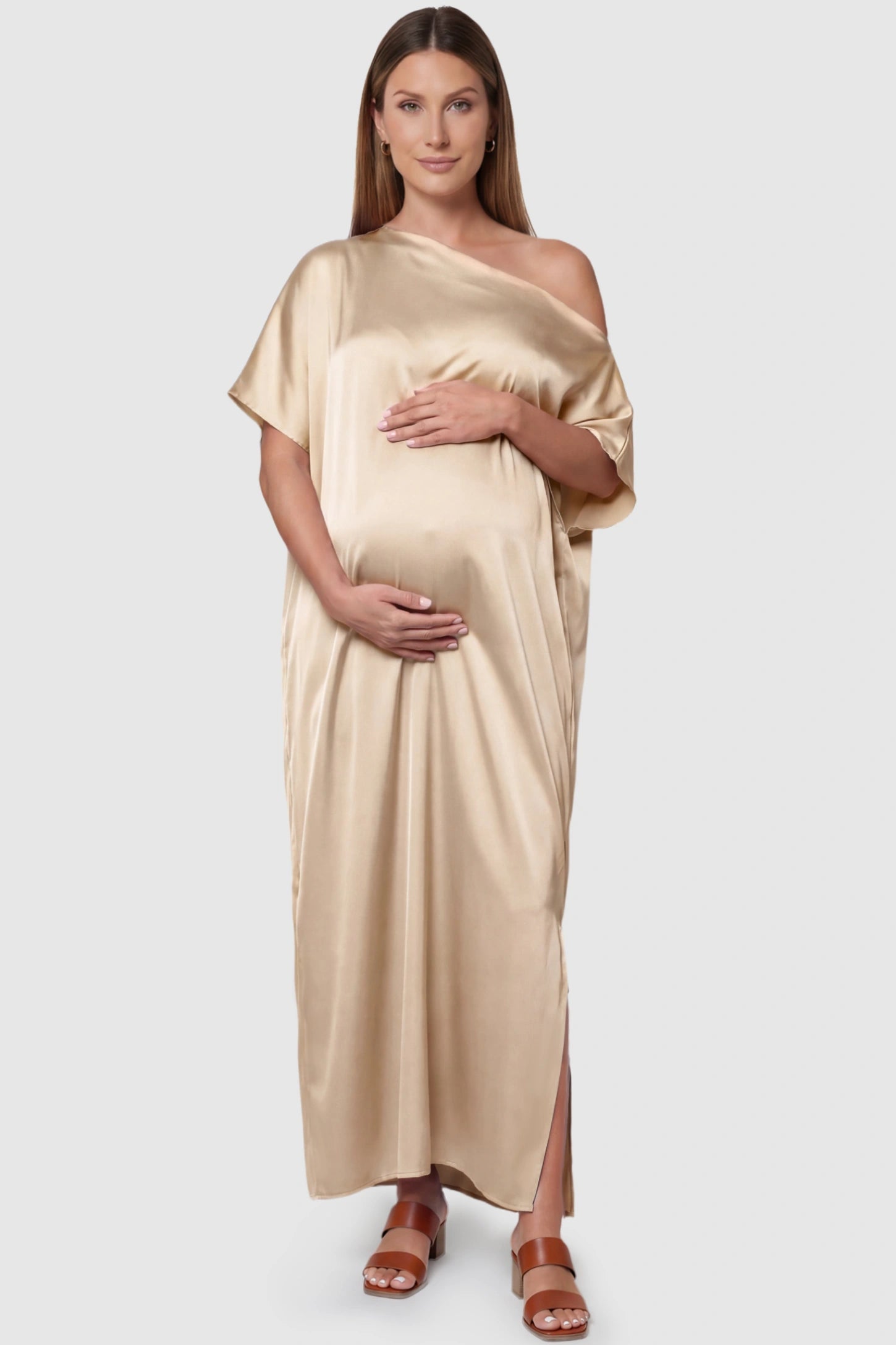 Satin One Shoulder Side Slit Maternity Maxi Dress in Apricot featuring a draped batwing sleeve on a pregnant model, front view.