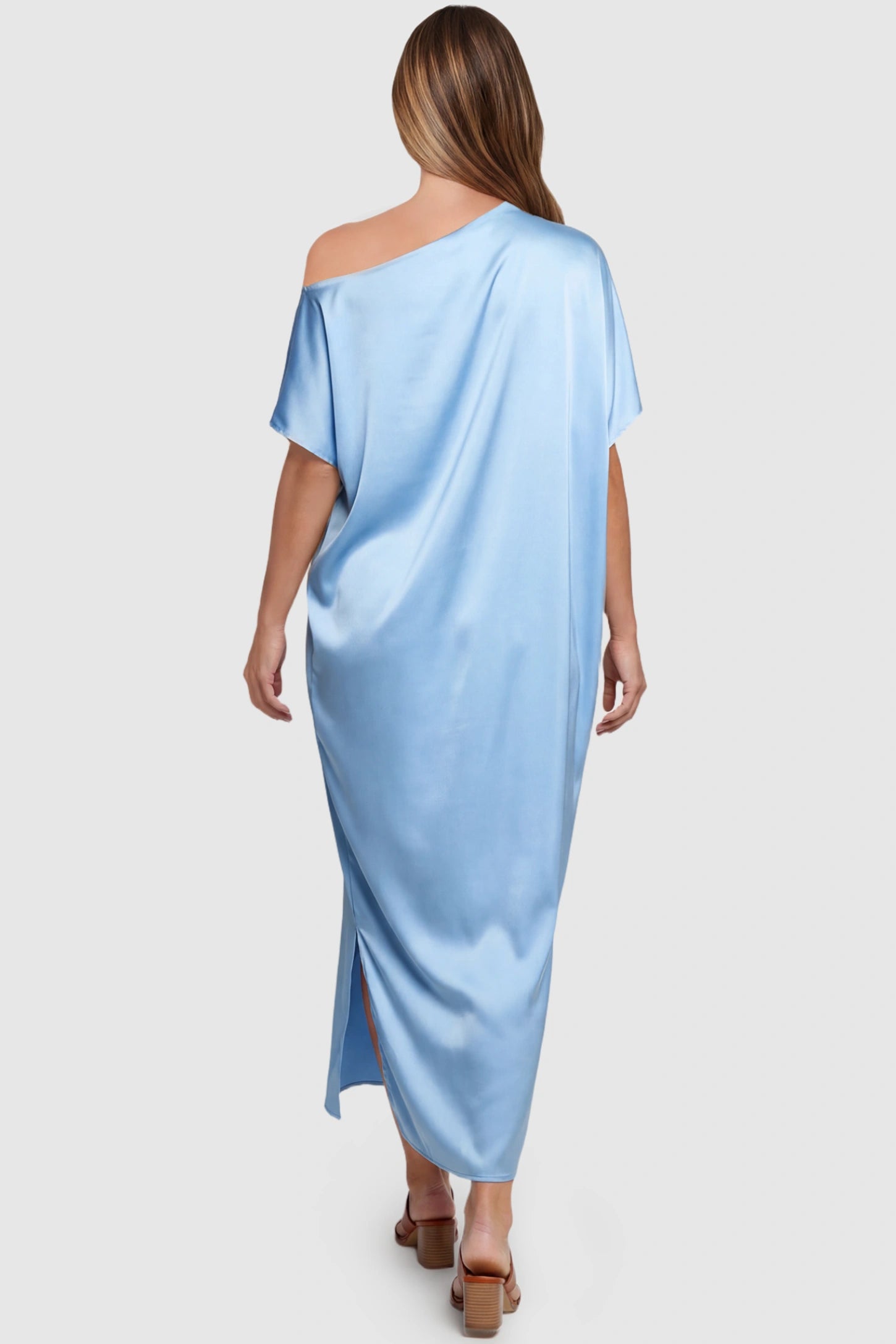Satin One Shoulder Side Slit Maternity Maxi Dress Satin One Shoulder Side Slit Maternity Maxi Dress in Blue featuring a draped batwing sleeve on a pregnant model, back view.