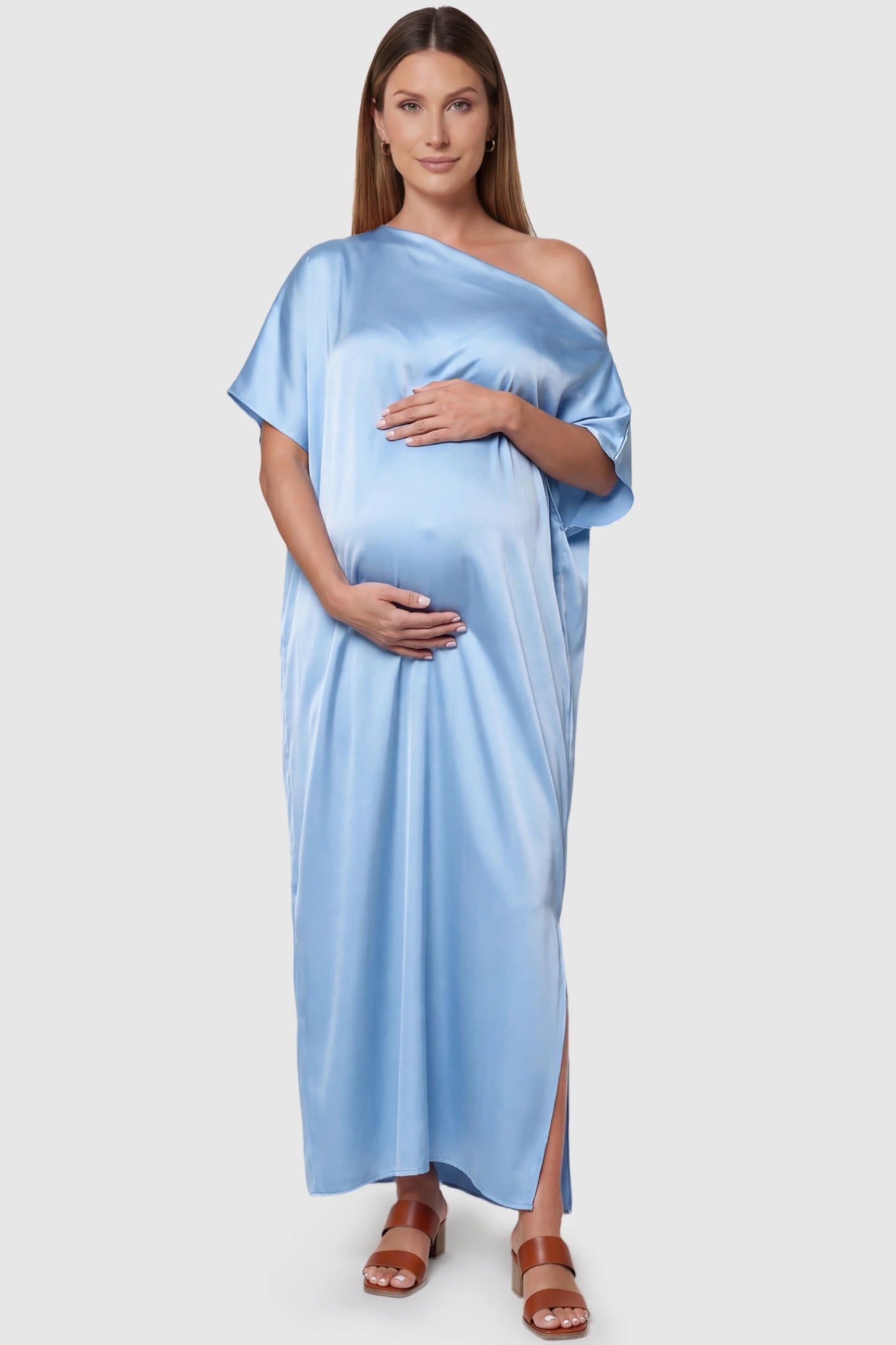 Satin One Shoulder Side Slit Maternity Maxi Dress Satin One Shoulder Side Slit Maternity Maxi Dress in Blue featuring a draped batwing sleeve on a pregnant model, front view.