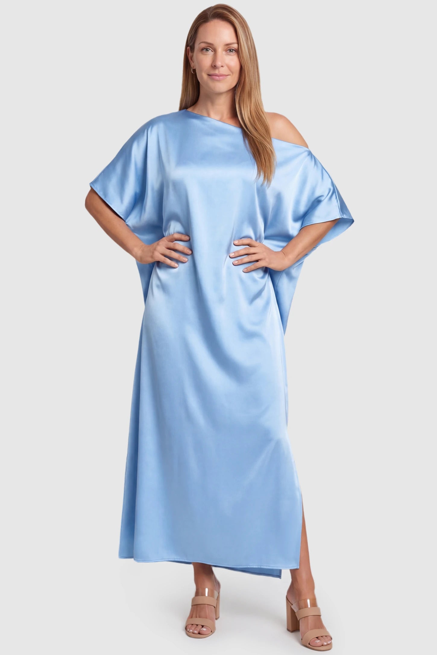 Satin One Shoulder Side Slit Maternity Maxi Dress Satin One Shoulder Side Slit Maternity Maxi Dress in Blue featuring a draped batwing sleeve on a postpartum model, front view.