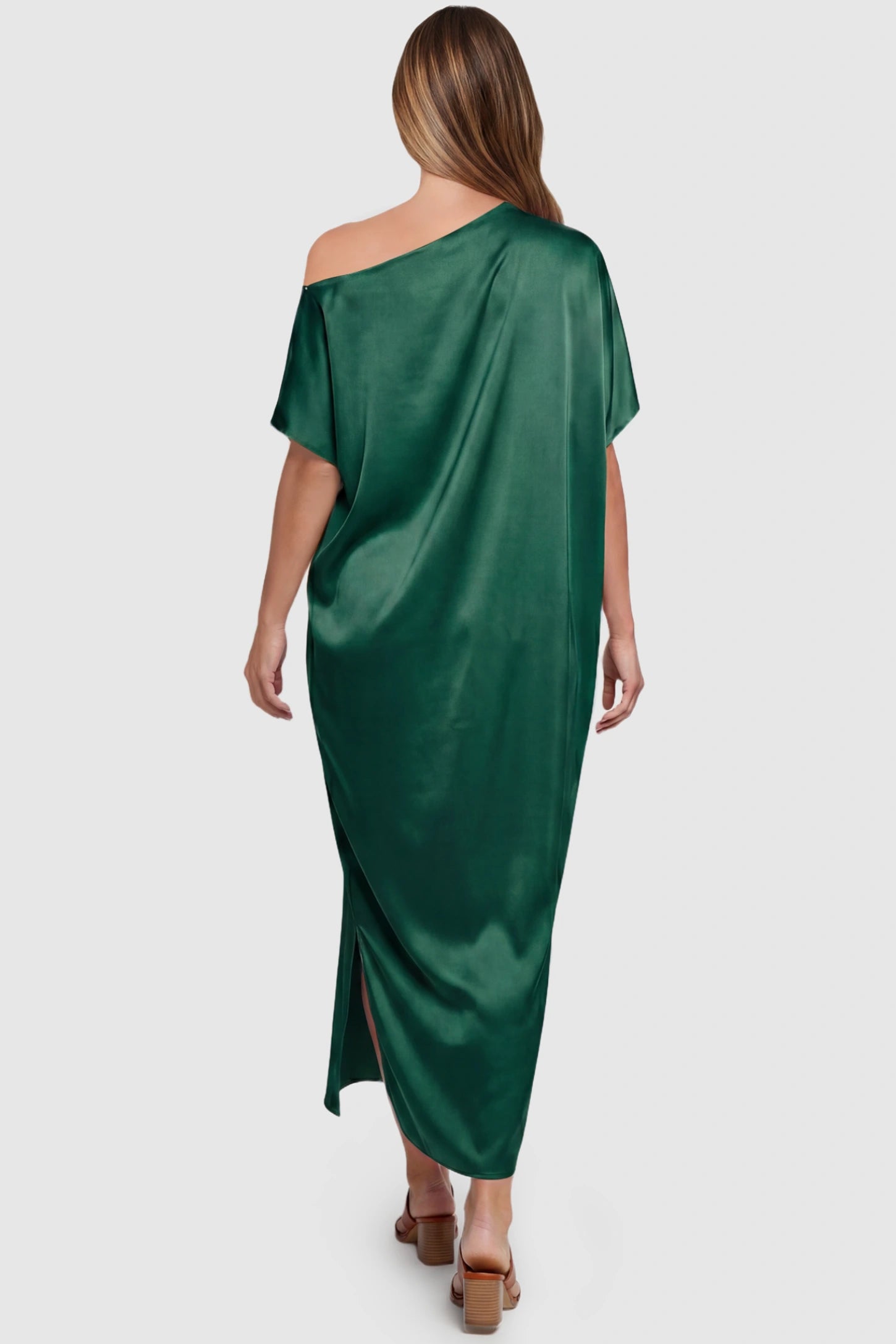 Satin One Shoulder Side Slit Maternity Maxi Dress Satin One Shoulder Side Slit Maternity Maxi Dress in Dark Green featuring a draped batwing sleeve on a pregnant model, back view.