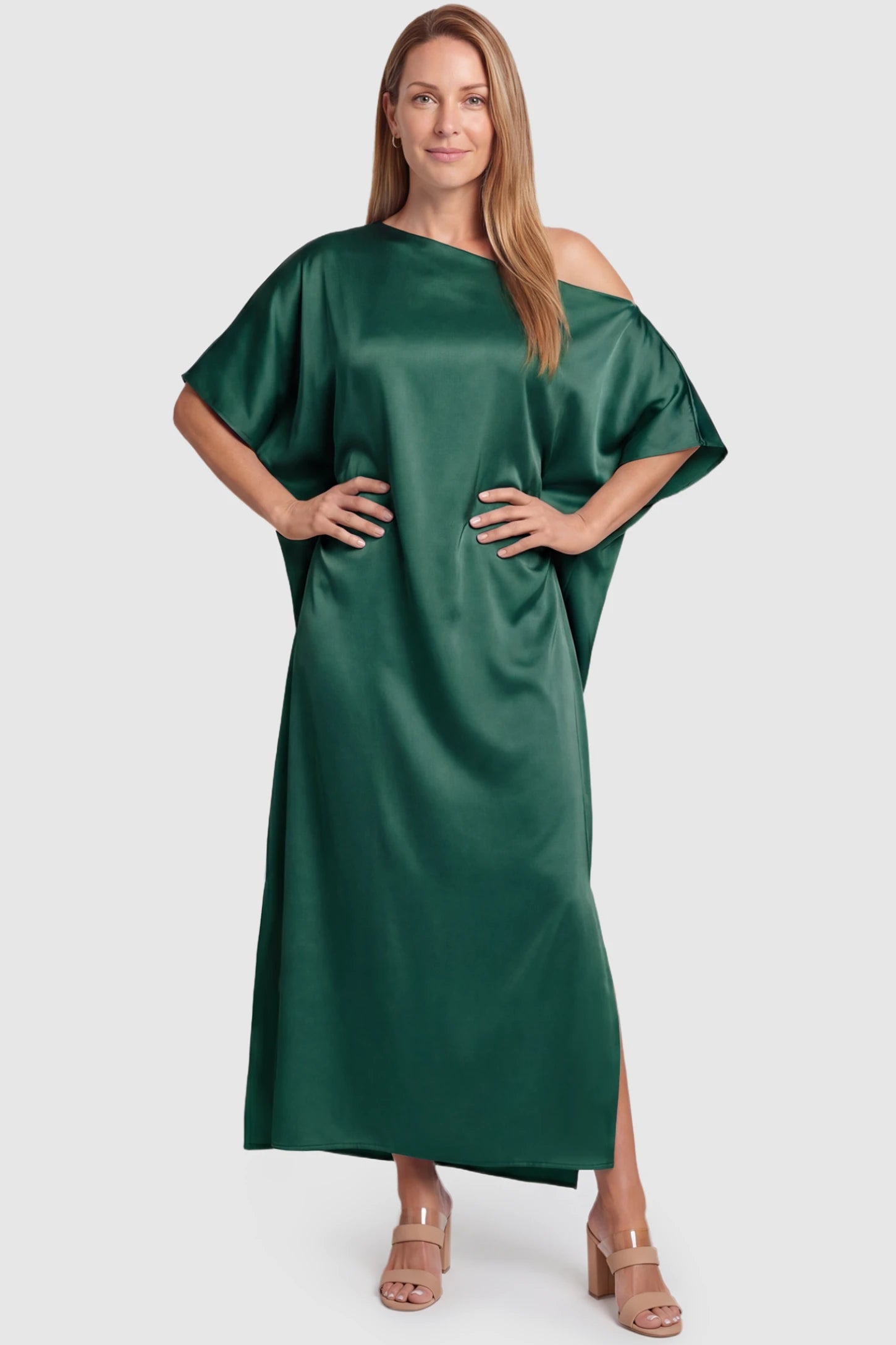 Satin One Shoulder Side Slit Maternity Maxi Dress Satin One Shoulder Side Slit Maternity Maxi Dress in Dark Green featuring a draped batwing sleeve on a postpartum model, front view.