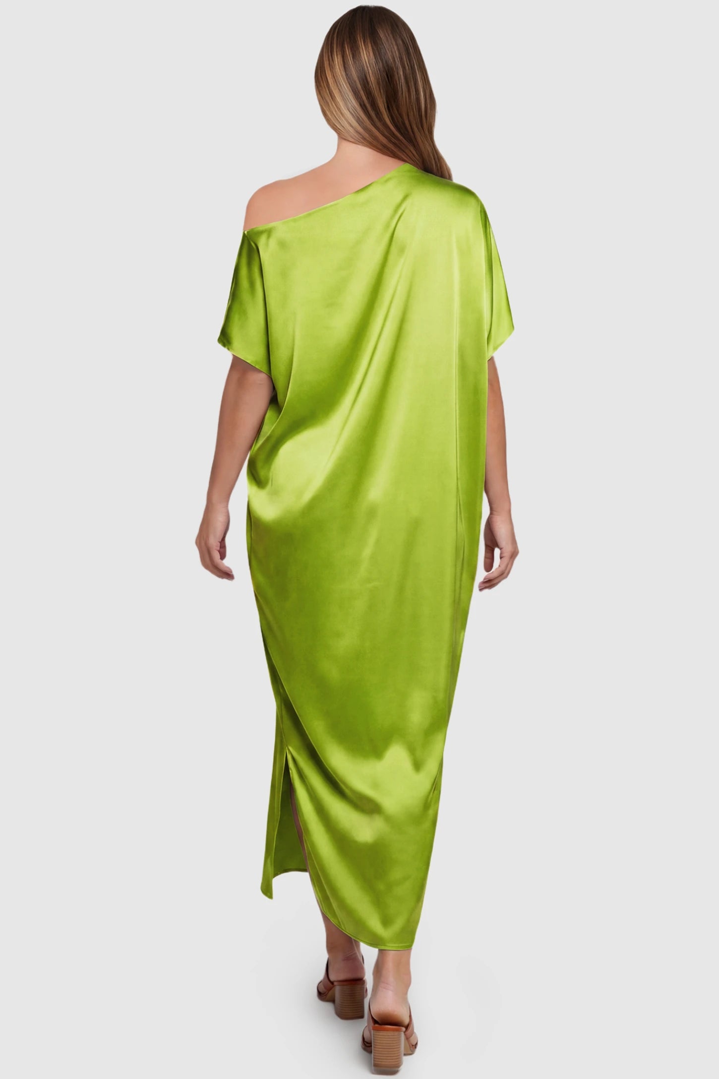 Satin One Shoulder Side Slit Maternity Maxi Dress Satin One Shoulder Side Slit Maternity Maxi Dress in Green featuring a draped batwing sleeve on a pregnant model, back view.