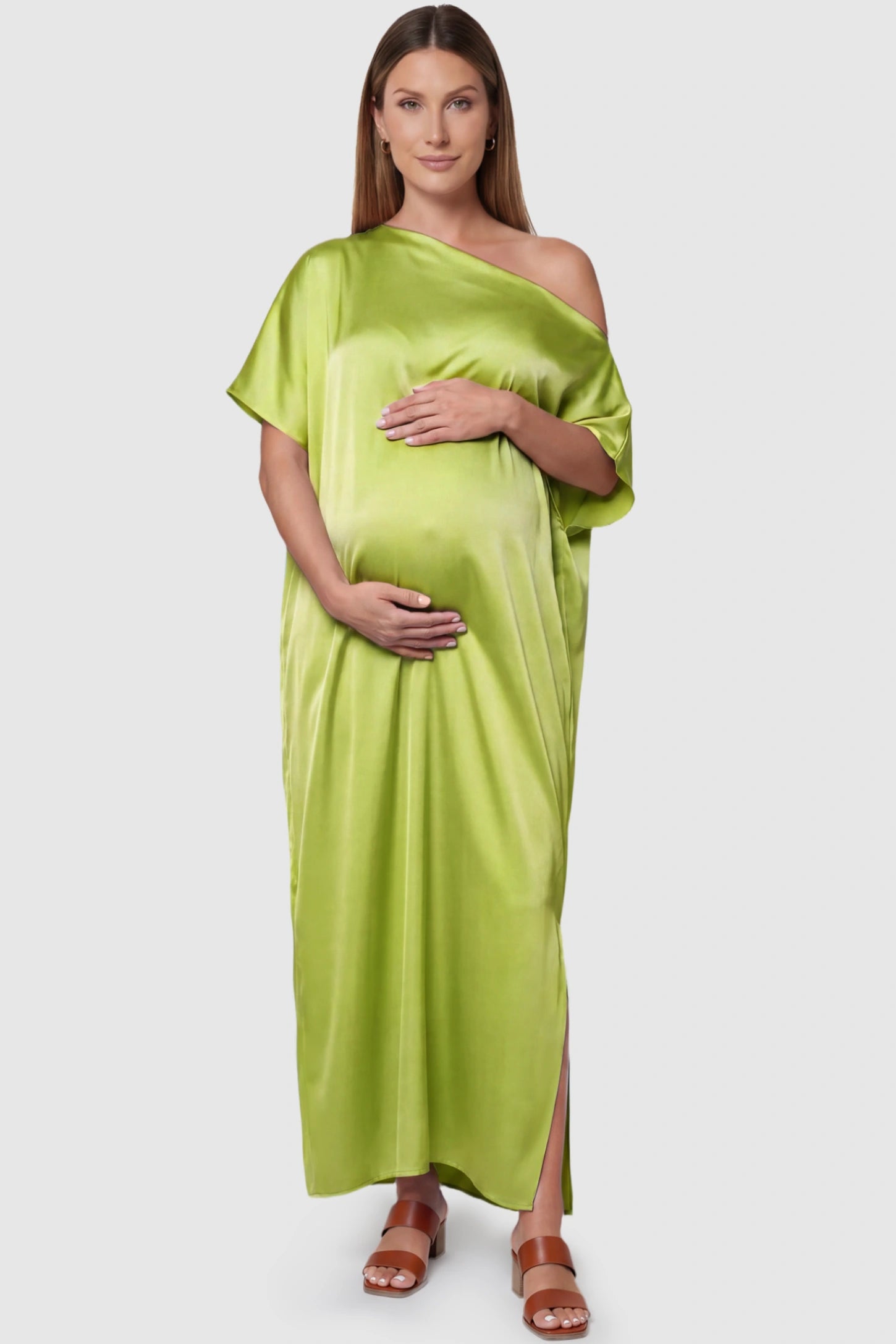 Satin One Shoulder Side Slit Maternity Maxi Dress Satin One Shoulder Side Slit Maternity Maxi Dress in Green featuring a draped batwing sleeve on a pregnant model, front view.