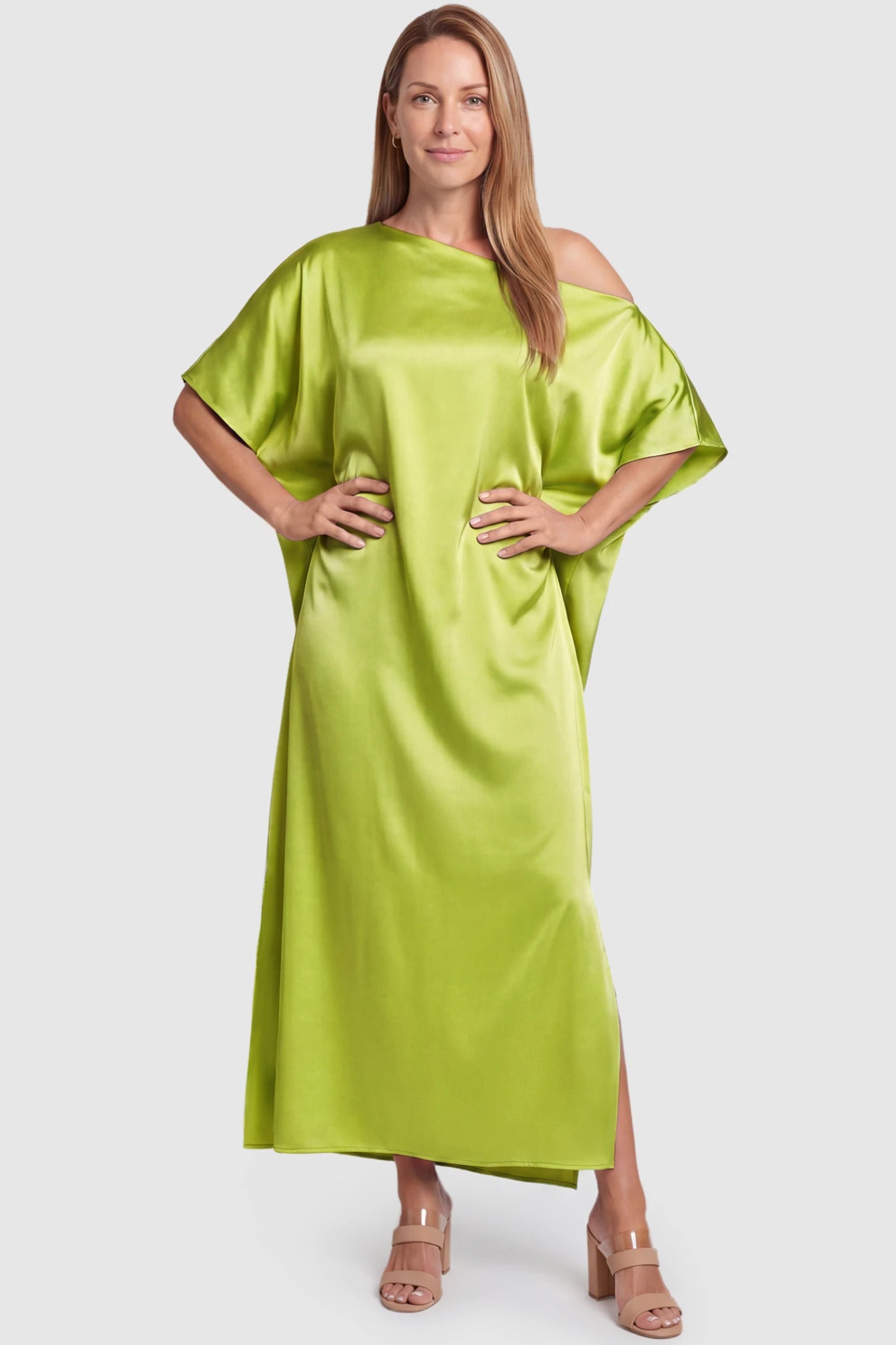 Satin One Shoulder Side Slit Maternity Maxi Dress Satin One Shoulder Side Slit Maternity Maxi Dress in Green featuring a draped batwing sleeve on a postpartum model, front view.