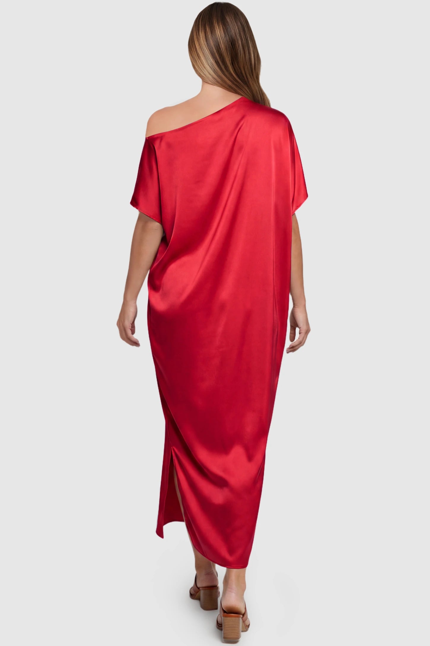 Satin One Shoulder Side Slit Maternity Maxi Dress Satin One Shoulder Side Slit Maternity Maxi Dress in Red featuring a draped batwing sleeve on a pregnant model, back view.