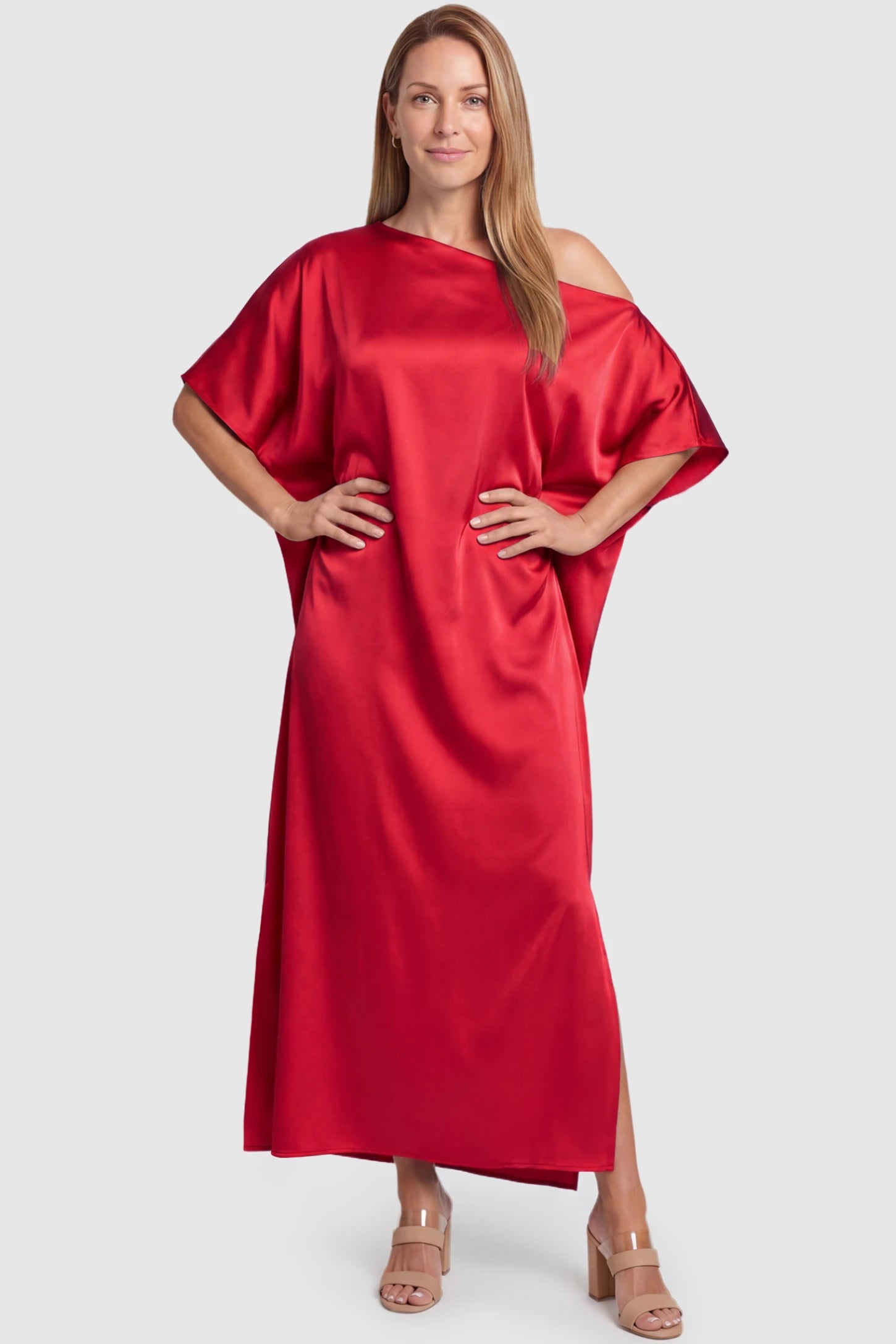 Satin One Shoulder Side Slit Maternity Maxi Dress Satin One Shoulder Side Slit Maternity Maxi Dress in Red featuring a draped batwing sleeve on a postpartum model, front view.