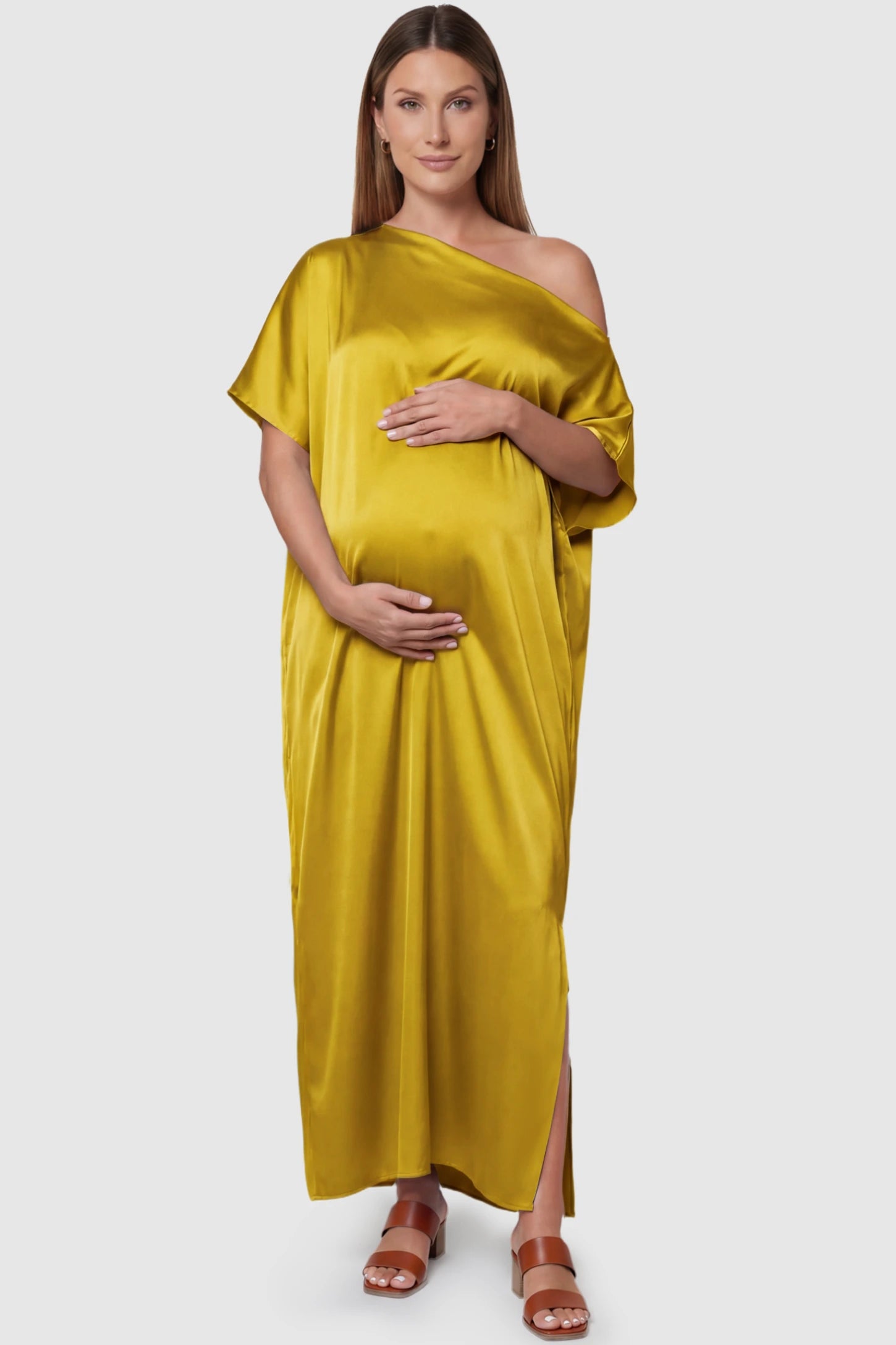 Satin One Shoulder Side Slit Maternity Maxi Dress Satin One Shoulder Side Slit Maternity Maxi Dress in Yellow featuring a draped batwing sleeve on a pregnant model, front view.