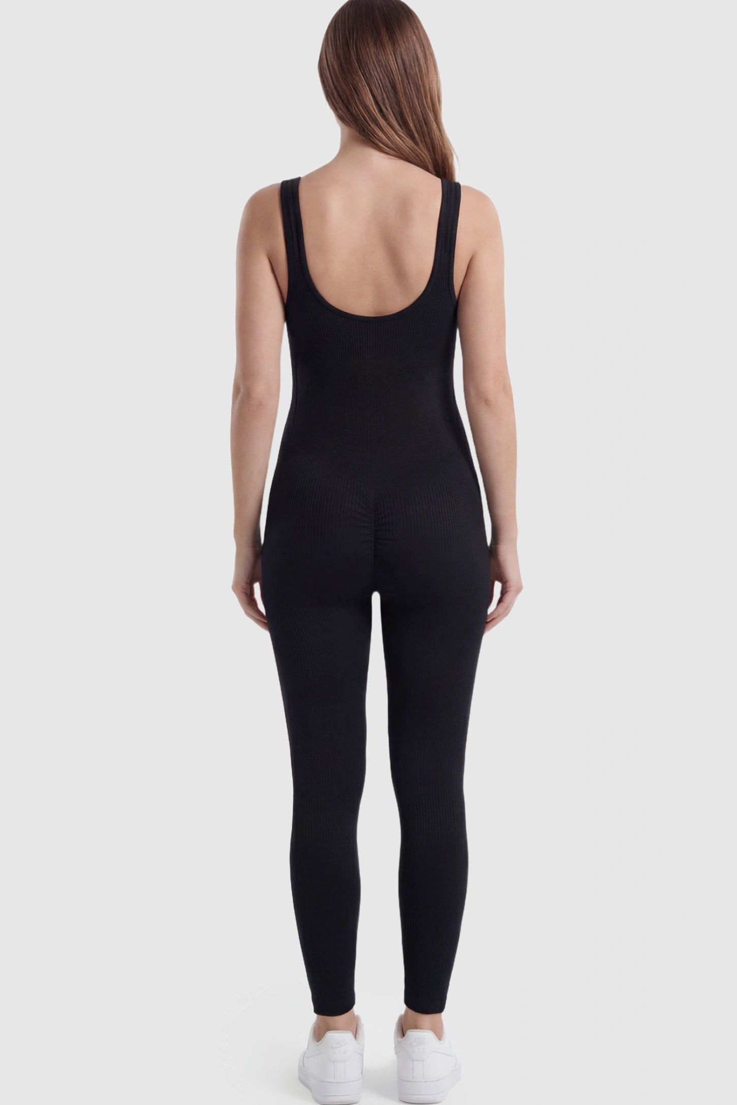 Scoop Neck Sleeveless Ribbed Bodycon Maternity Jumpsuit Scoop Neck Sleeveless Ribbed Bodycon Maternity Jumpsuit in Black featuring ribbed knit texture on a pregnant model showing back.