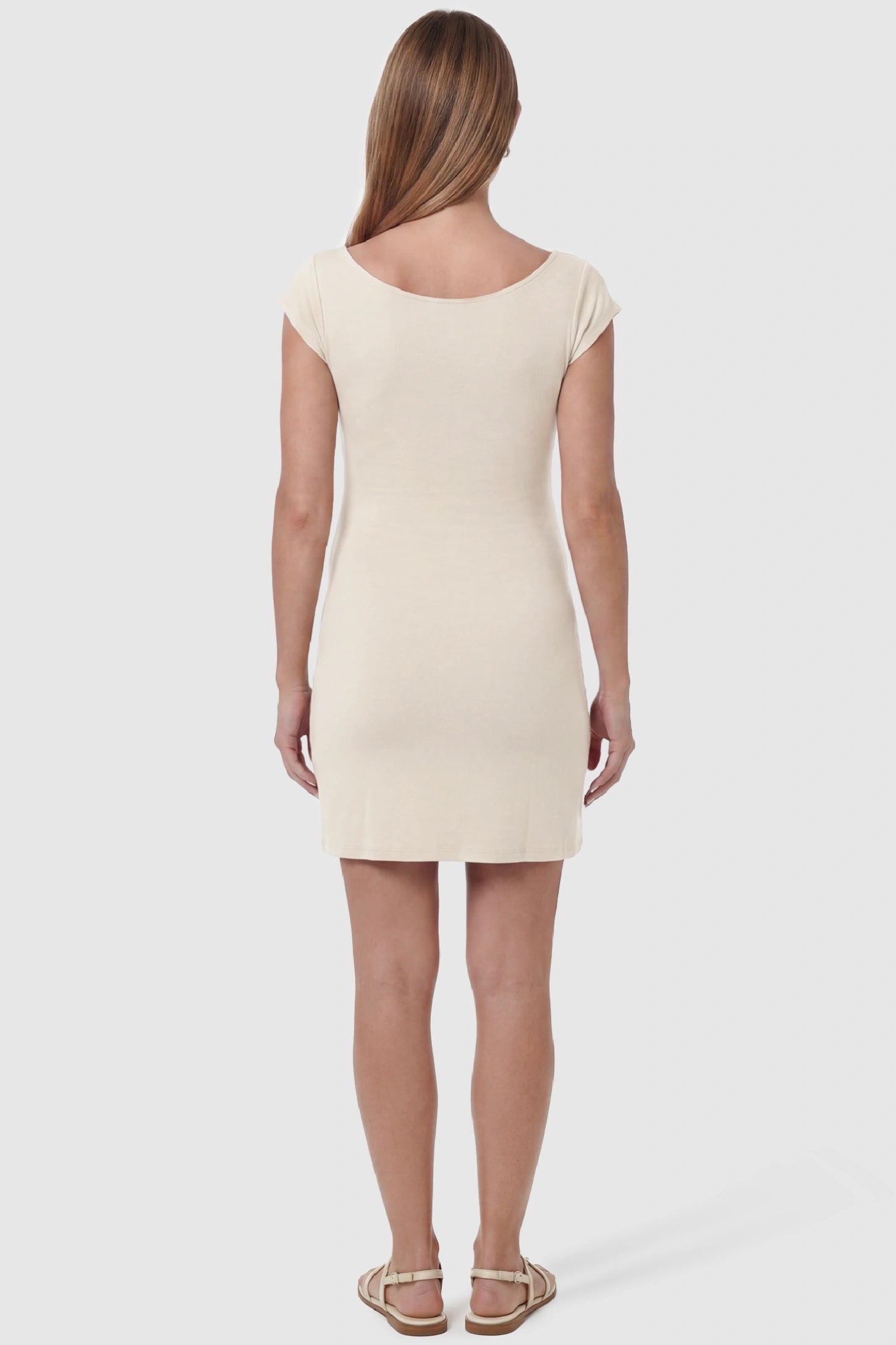 Side Ruched Boat Neck Maternity Mini Dress Side Ruched Boat Neck Maternity Mini Dress in Beige featuring a high Soft knit stretch fit on a pregnant model, back view.