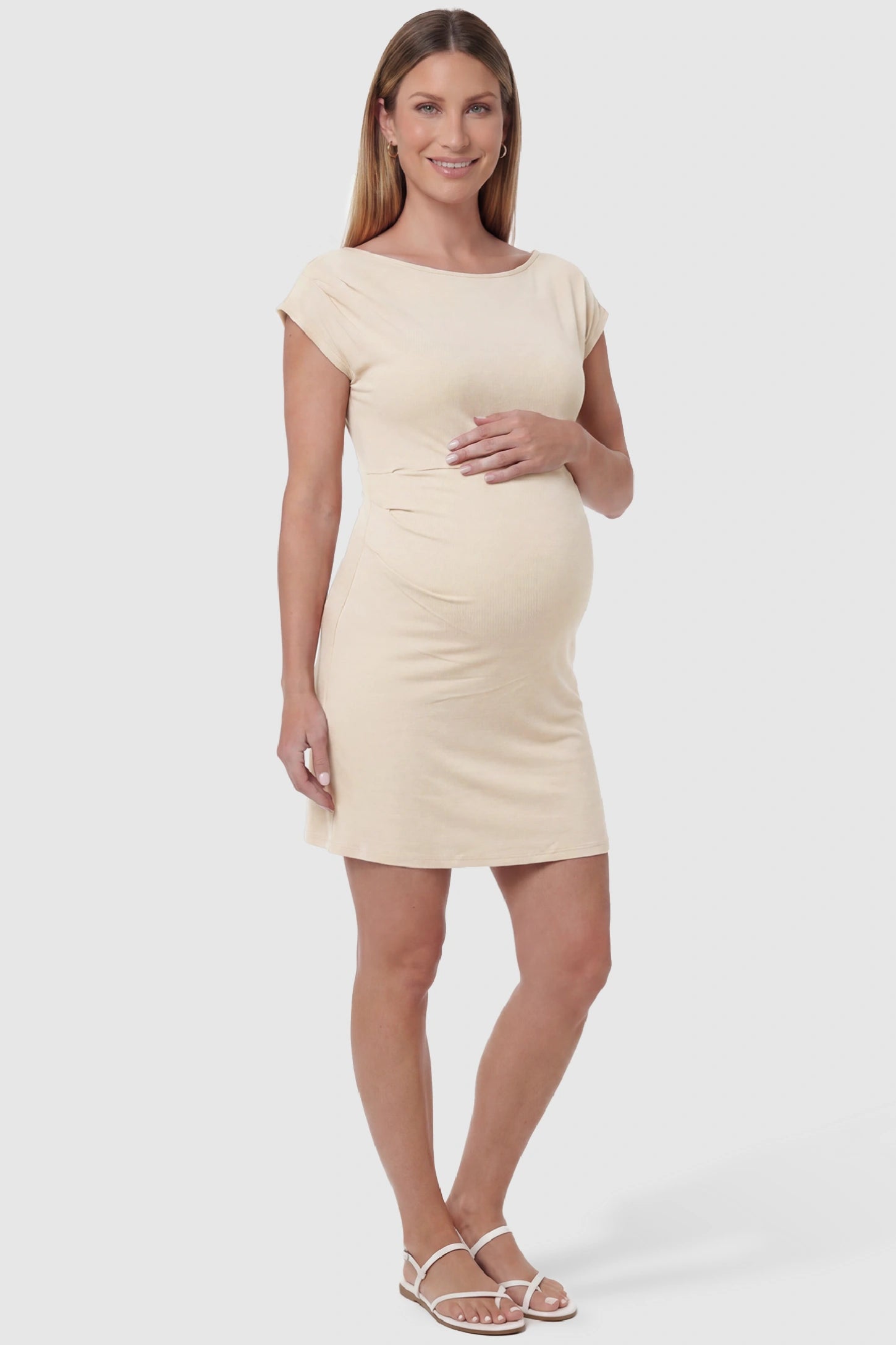 Side Ruched Boat Neck Maternity Mini Dress Side Ruched Boat Neck Maternity Mini Dress in Beige featuring side ruching at the waist on a pregnant model, front view.