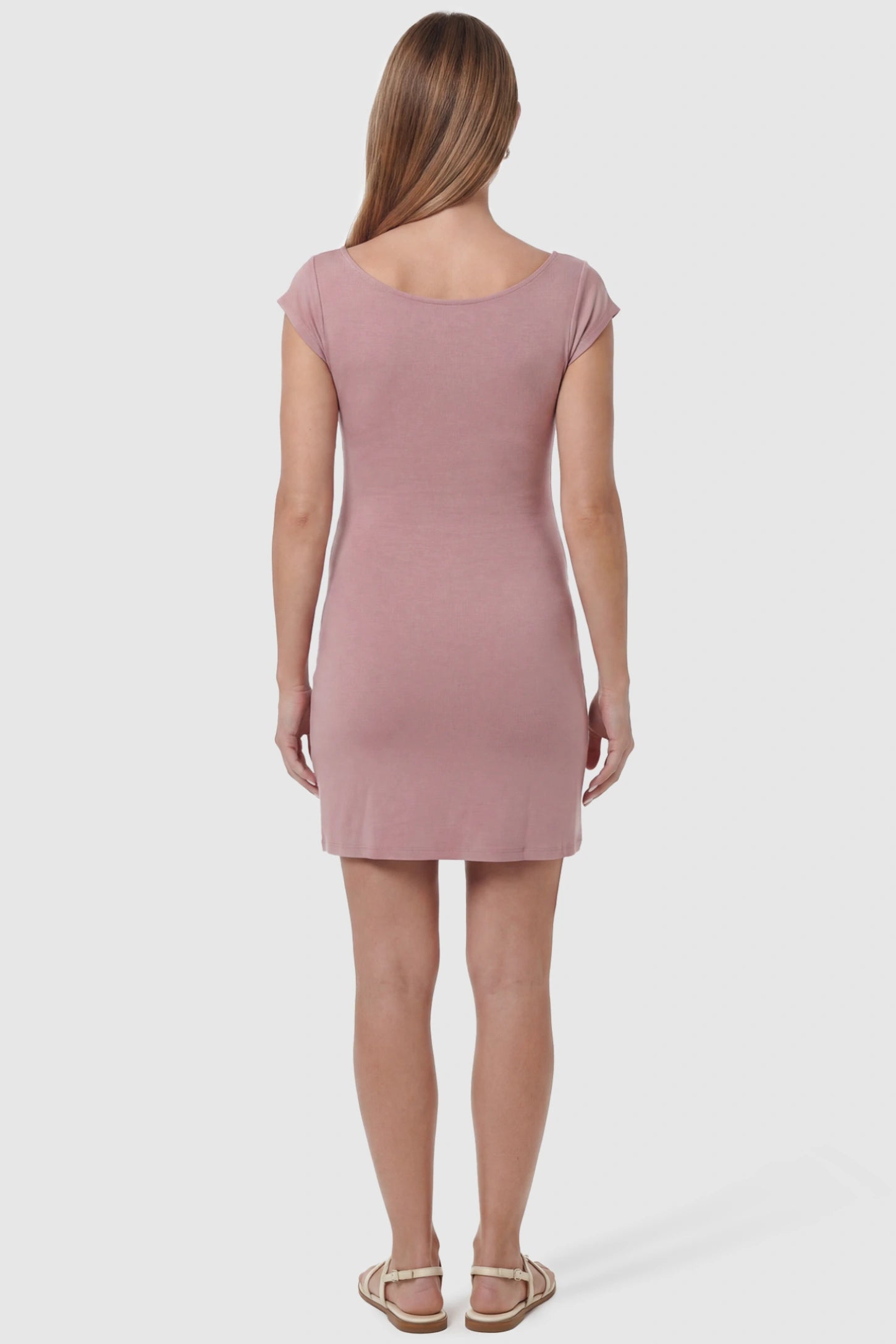 Side Ruched Boat Neck Maternity Mini Dress Side Ruched Boat Neck Maternity Mini Dress in Pink featuring a high Soft knit stretch fit on a pregnant model, back view.