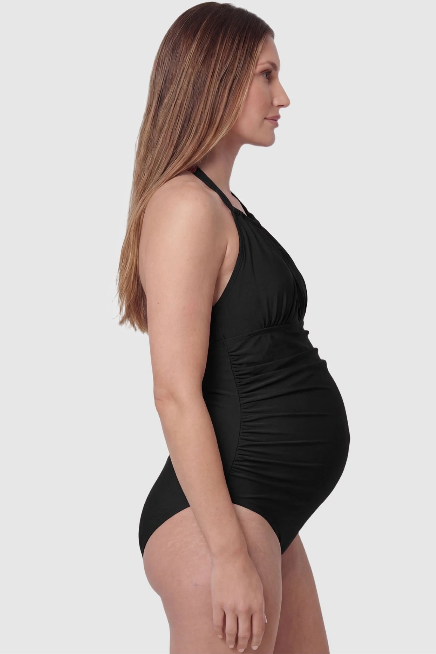 Side-Ruched Halter Maternity One-Piece Side-Ruched Halter Maternity One-Piece in Black featuring supportive side-ruching on a pregnant model, side view.