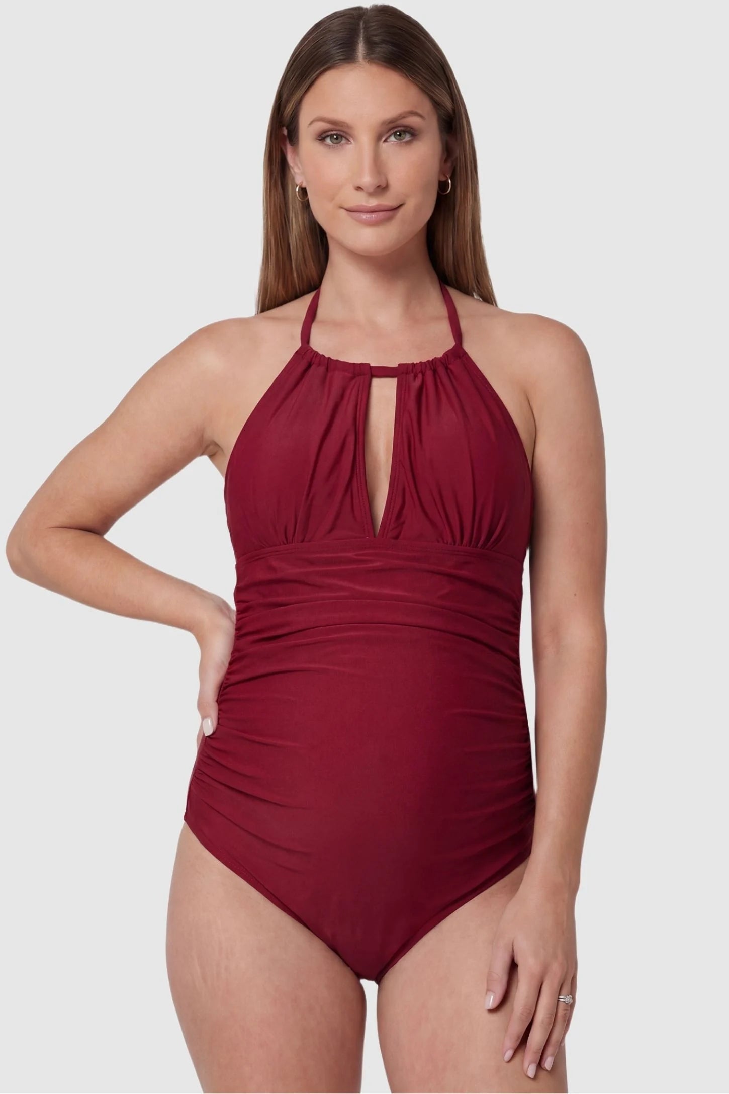 Side-Ruched Halter Maternity One-Piece Side-Ruched Halter Maternity One-Piece in Red featuring a keyhole neckline and side-ruching on a pregnant model, front view.