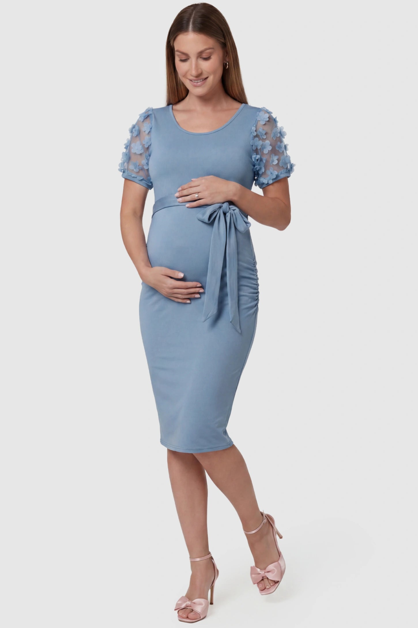 Side Ruched Round Neck Short Sleeve Maternity Short Dress Side Ruched Round Neck Short Sleeve Maternity Short Dress in light blue featuring floral-detailed sleeves on a pregnant model, front view.