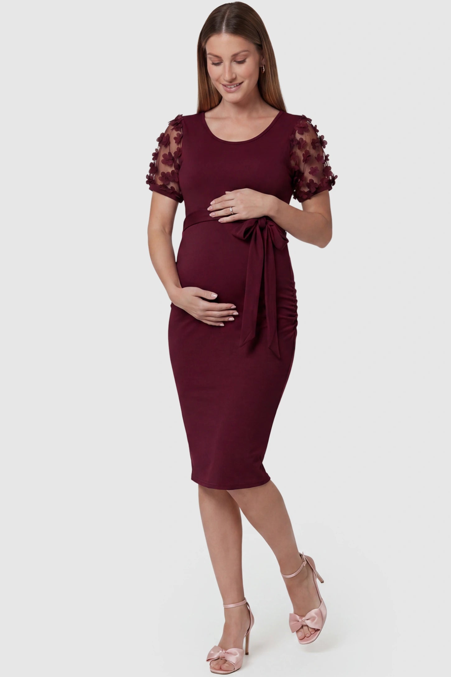 Side Ruched Round Neck Short Sleeve Maternity Short Dress Side Ruched Round Neck Short Sleeve Maternity Short Dress in wine red featuring floral-detailed sleeves on a pregnant model, front view.
