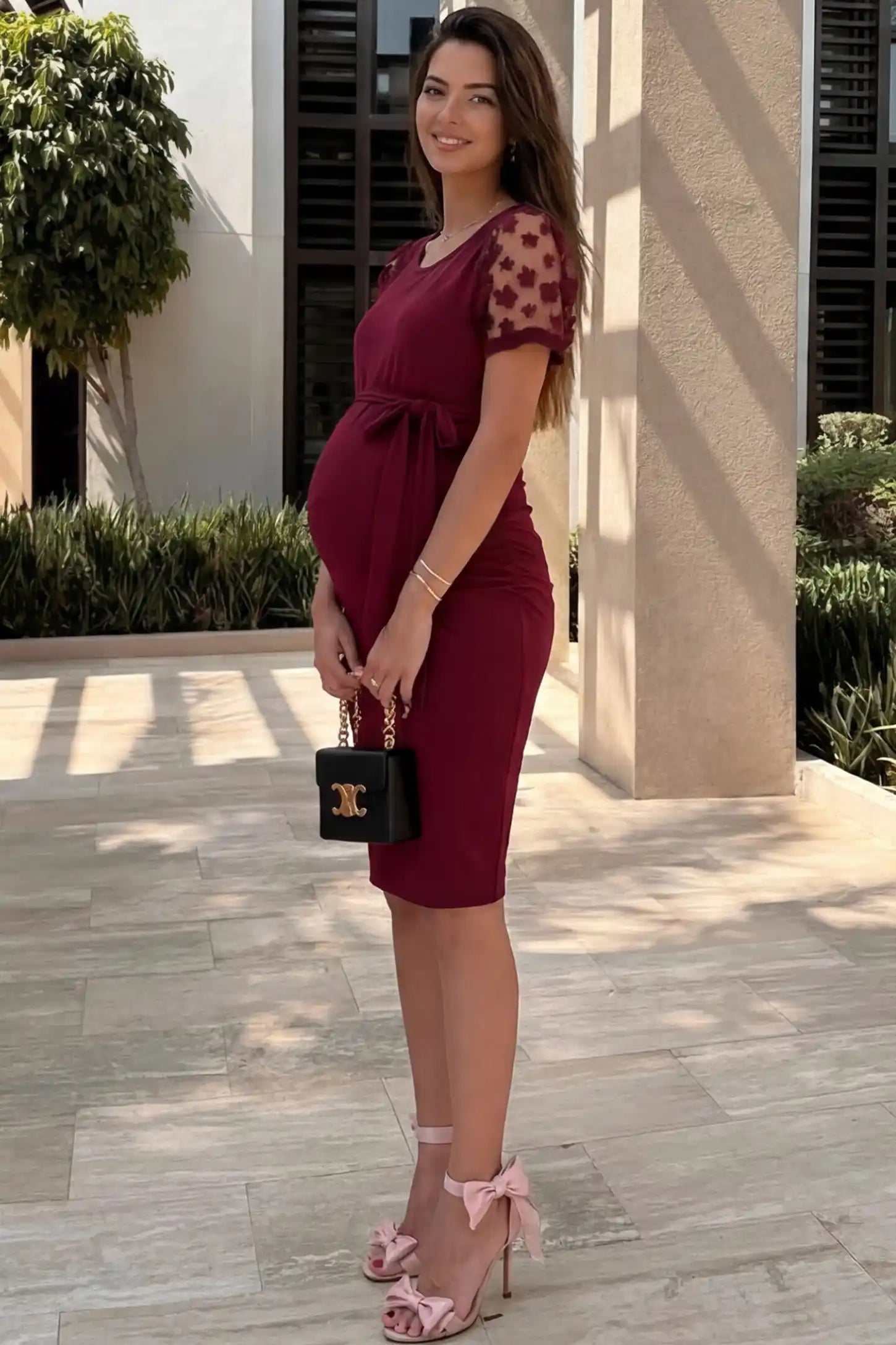 Side Ruched Round Neck Short Sleeve Maternity Short Dress Side Ruched Round Neck Short Sleeve Maternity Short Dress in wine red featuring floral-detailed sleeves on a pregnant woman in outdoor setting, side view.