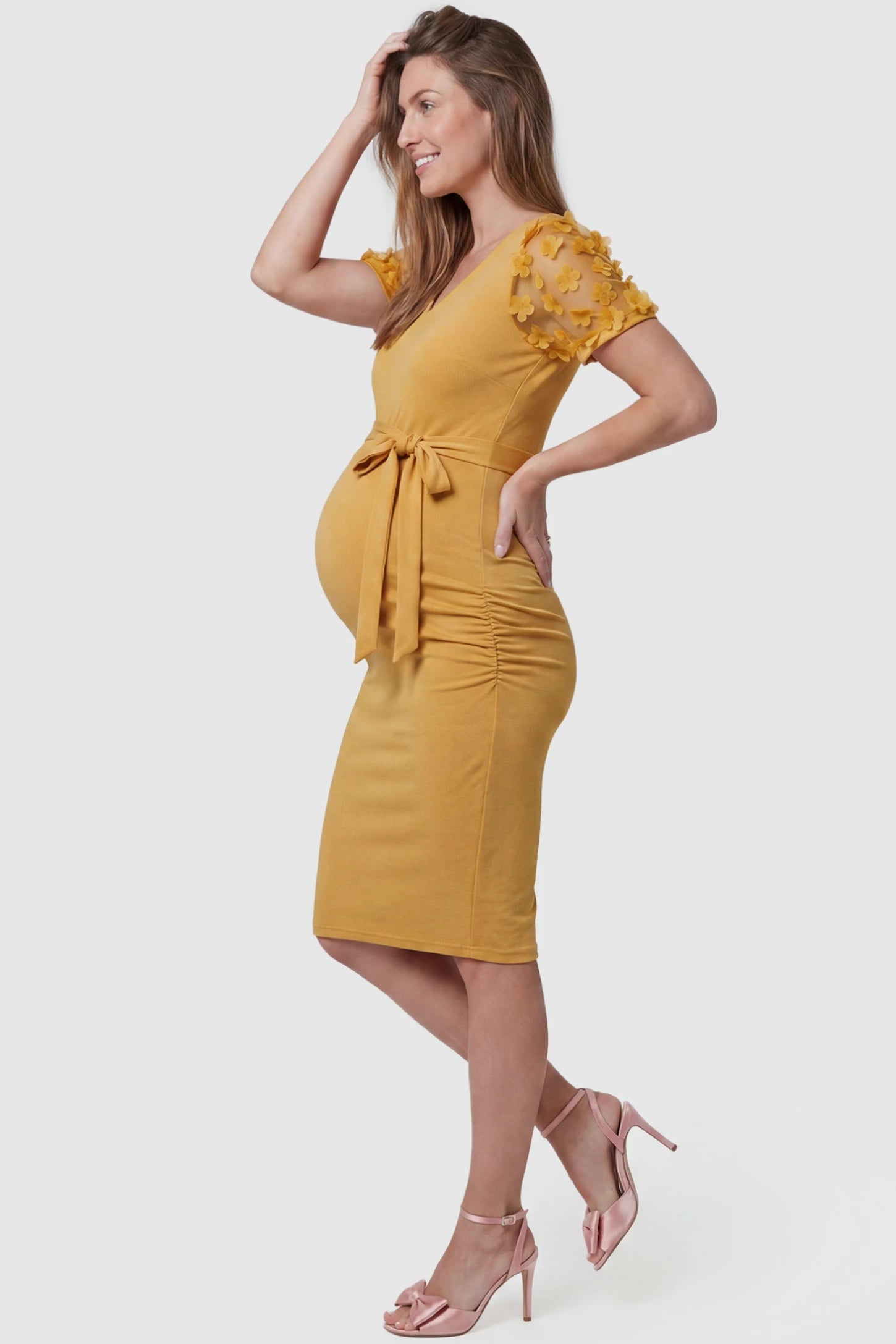 Side Ruched Round Neck Short Sleeve Maternity Short Dress Side Ruched Round Neck Short Sleeve Maternity Short Dress in yellow featuring floral-detailed sleeves on a pregnant model, side view.