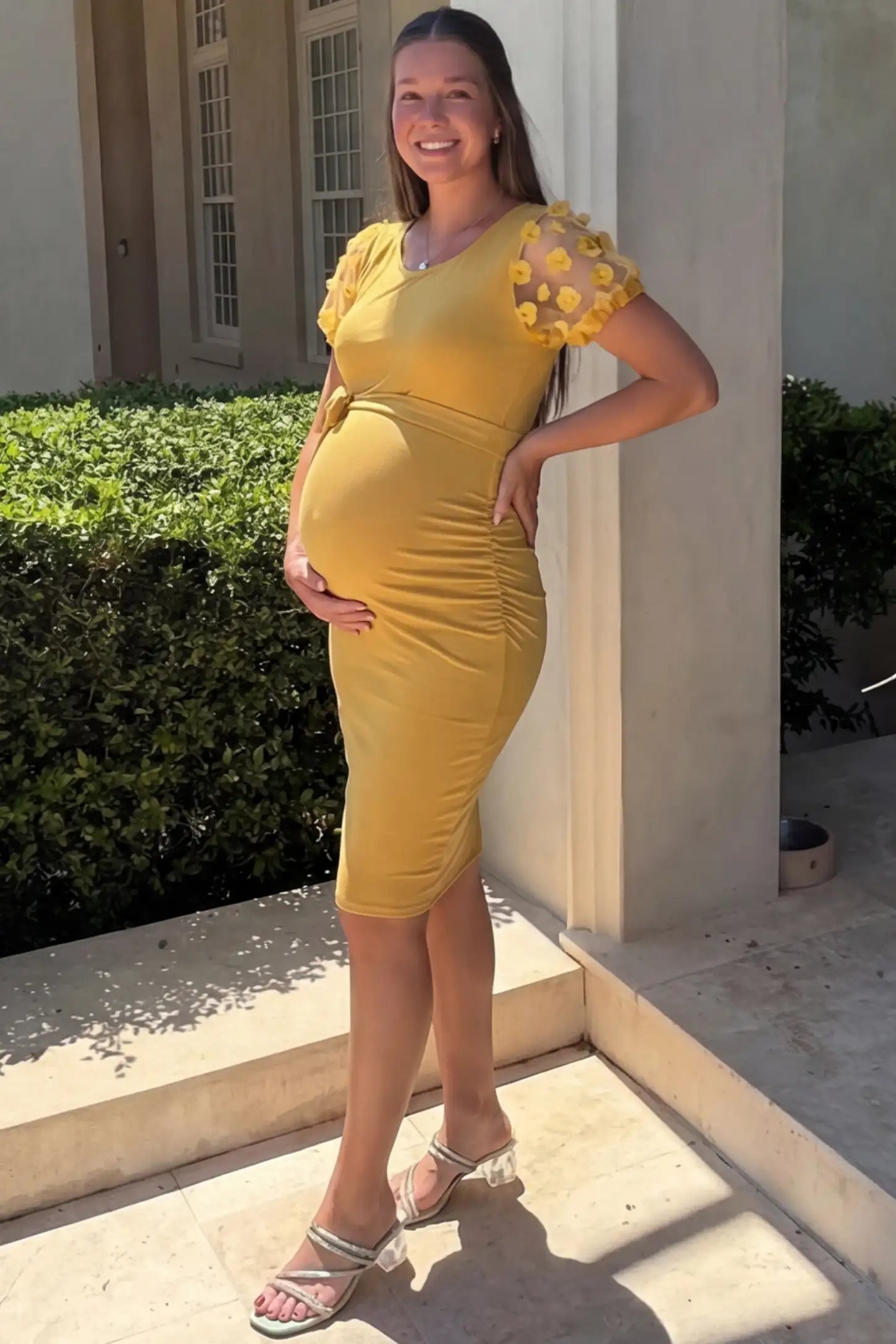 Side Ruched Round Neck Short Sleeve Maternity Short Dress Side Ruched Round Neck Short Sleeve Maternity Short Dress in yellow featuring floral-detailed sleeves on a pregnant woman in outdoor setting, side view.