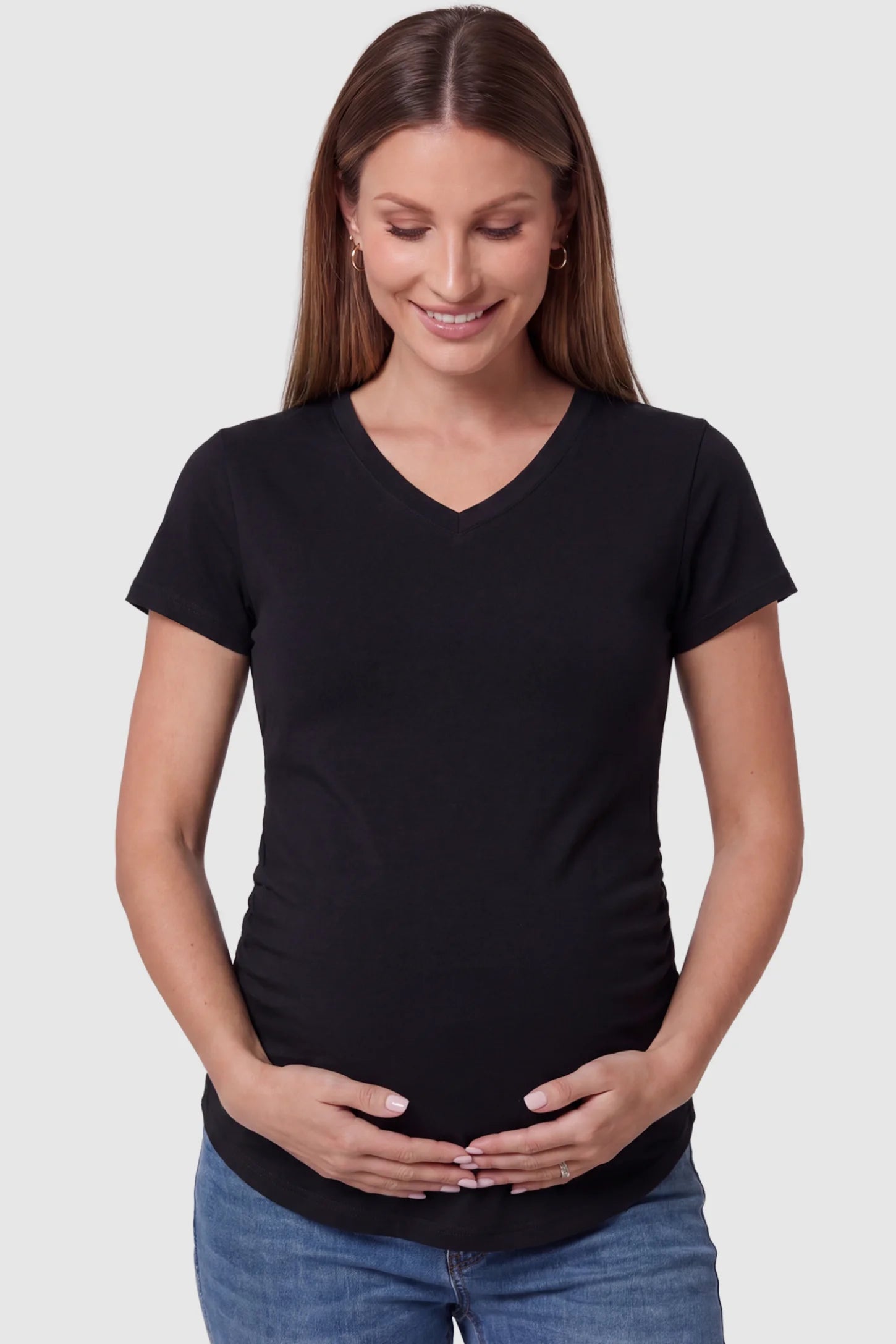 Side Ruched V-Neck Short Sleeve Maternity T-Shirt in Black featuring breathable fabric and ruching on sides on a pregnant model, front view.