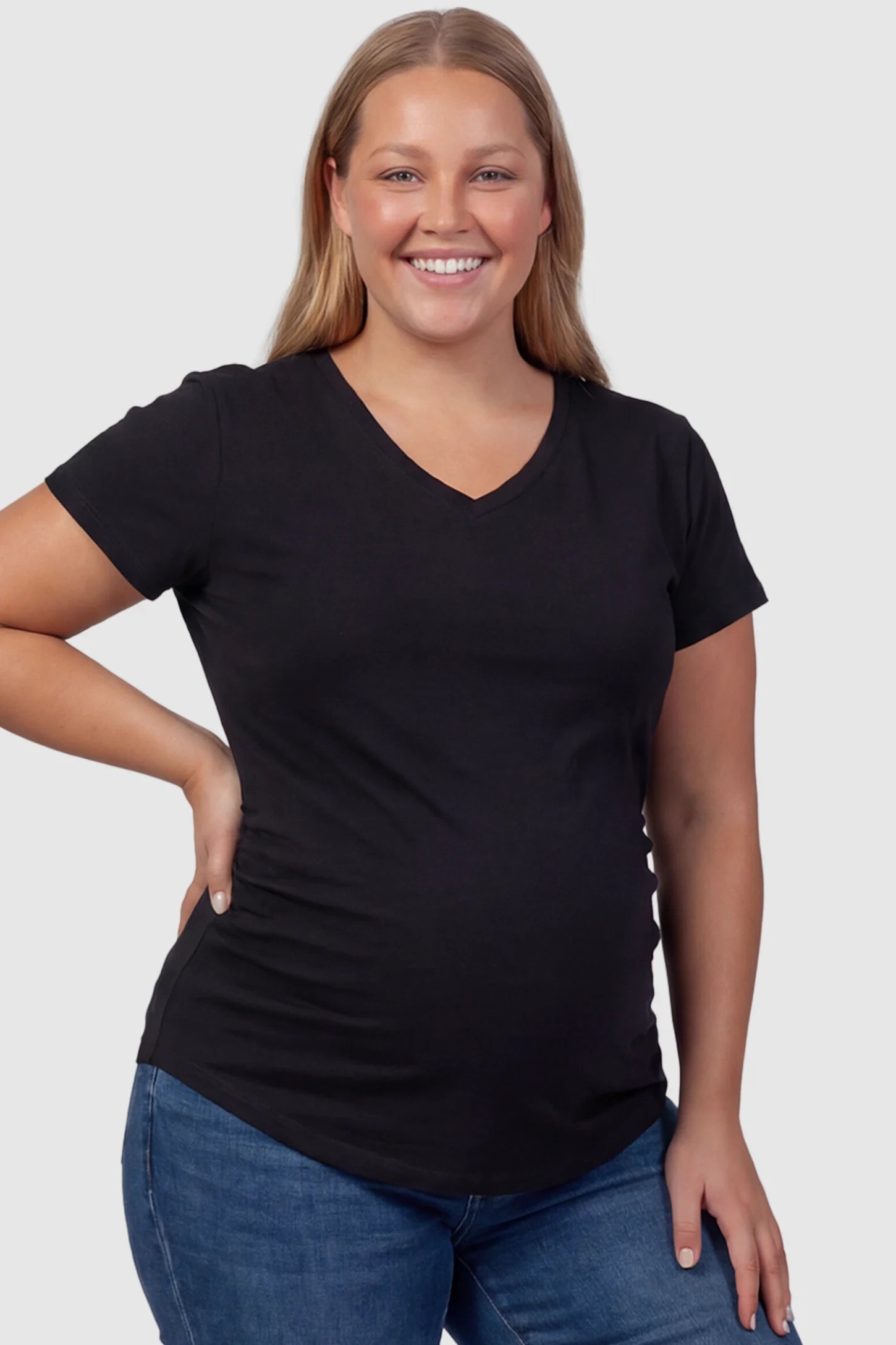 Side Ruched V-Neck Short Sleeve Maternity T-Shirt Side Ruched V-Neck Short Sleeve Maternity T-Shirt in Black featuring breathable fabric and ruching on sides on a plus size pregnant model, front view.