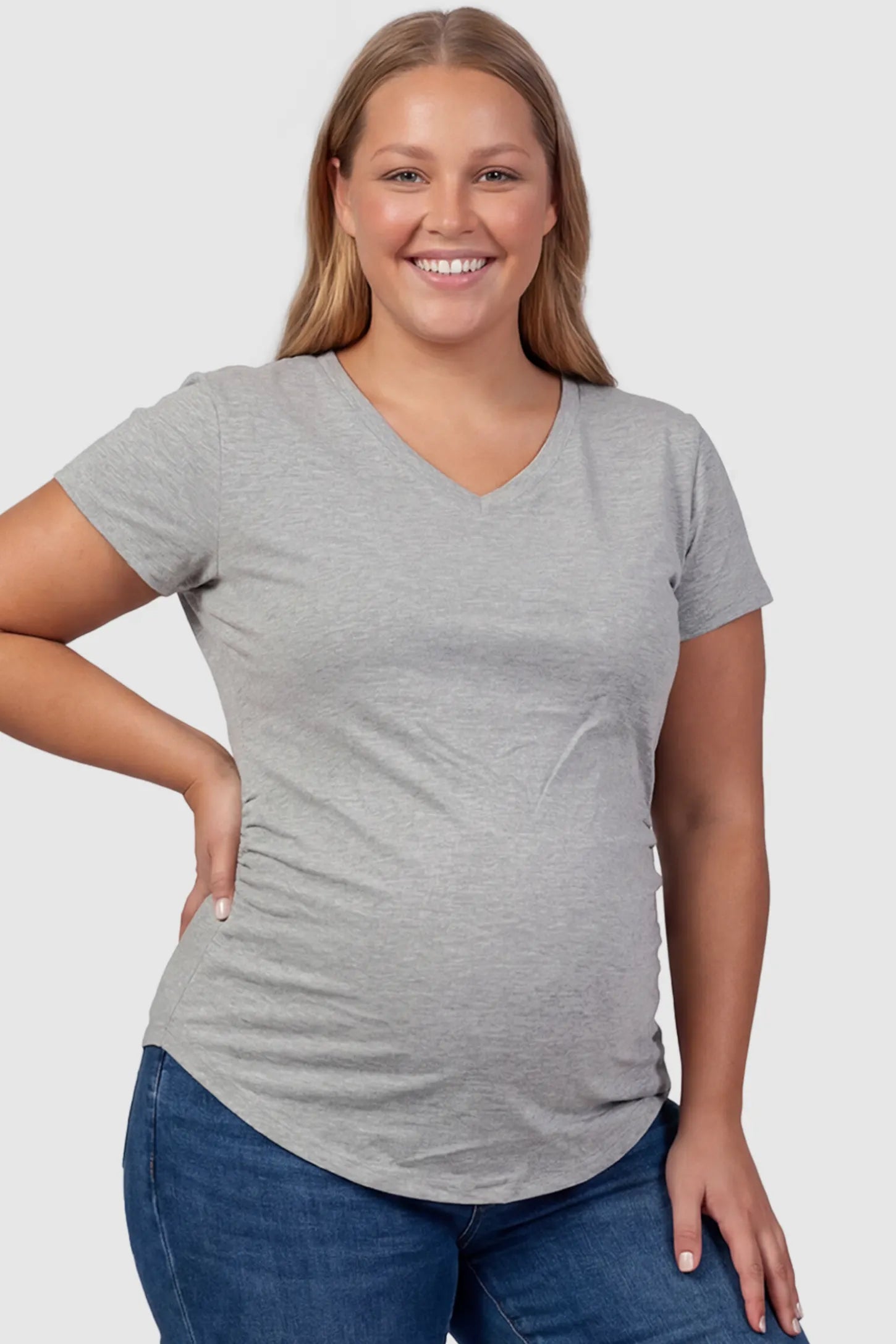 Side Ruched V-Neck Short Sleeve Maternity T-Shirt Side Ruched V-Neck Short Sleeve Maternity T-Shirt in Gray featuring breathable fabric and ruching on sides on a plus size pregnant model, front view.