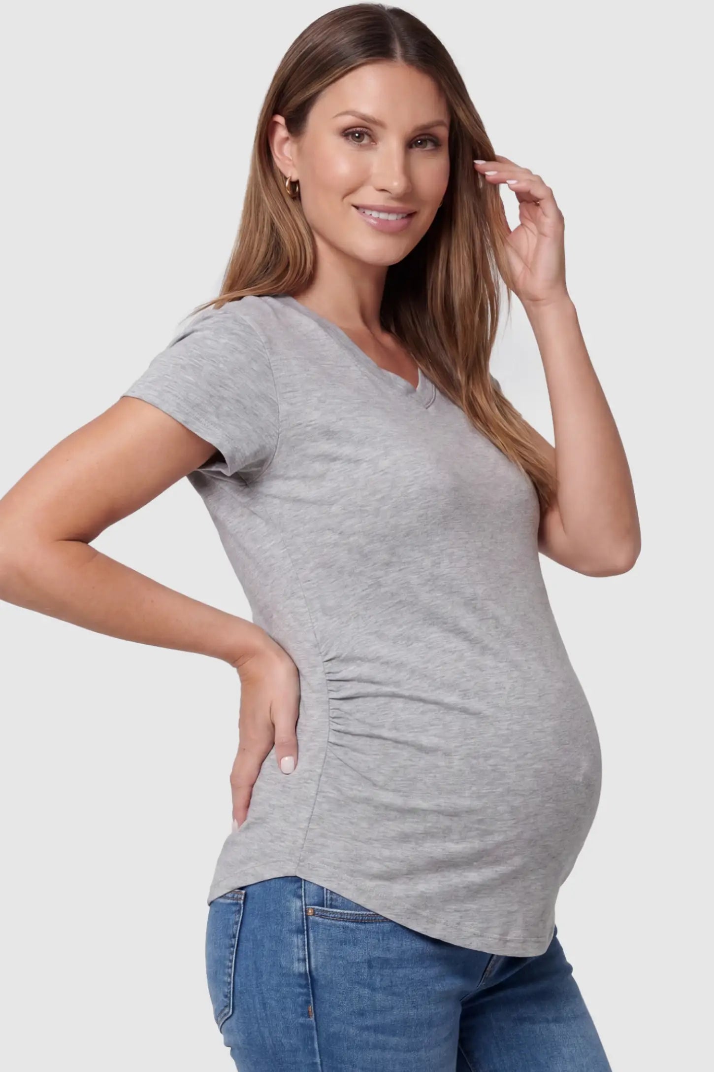 Side Ruched V-Neck Short Sleeve Maternity T-Shirt Side Ruched V-Neck Short Sleeve Maternity T-Shirt in Gray featuring breathable fabric and ruching on sides on a pregnant model, side view.
