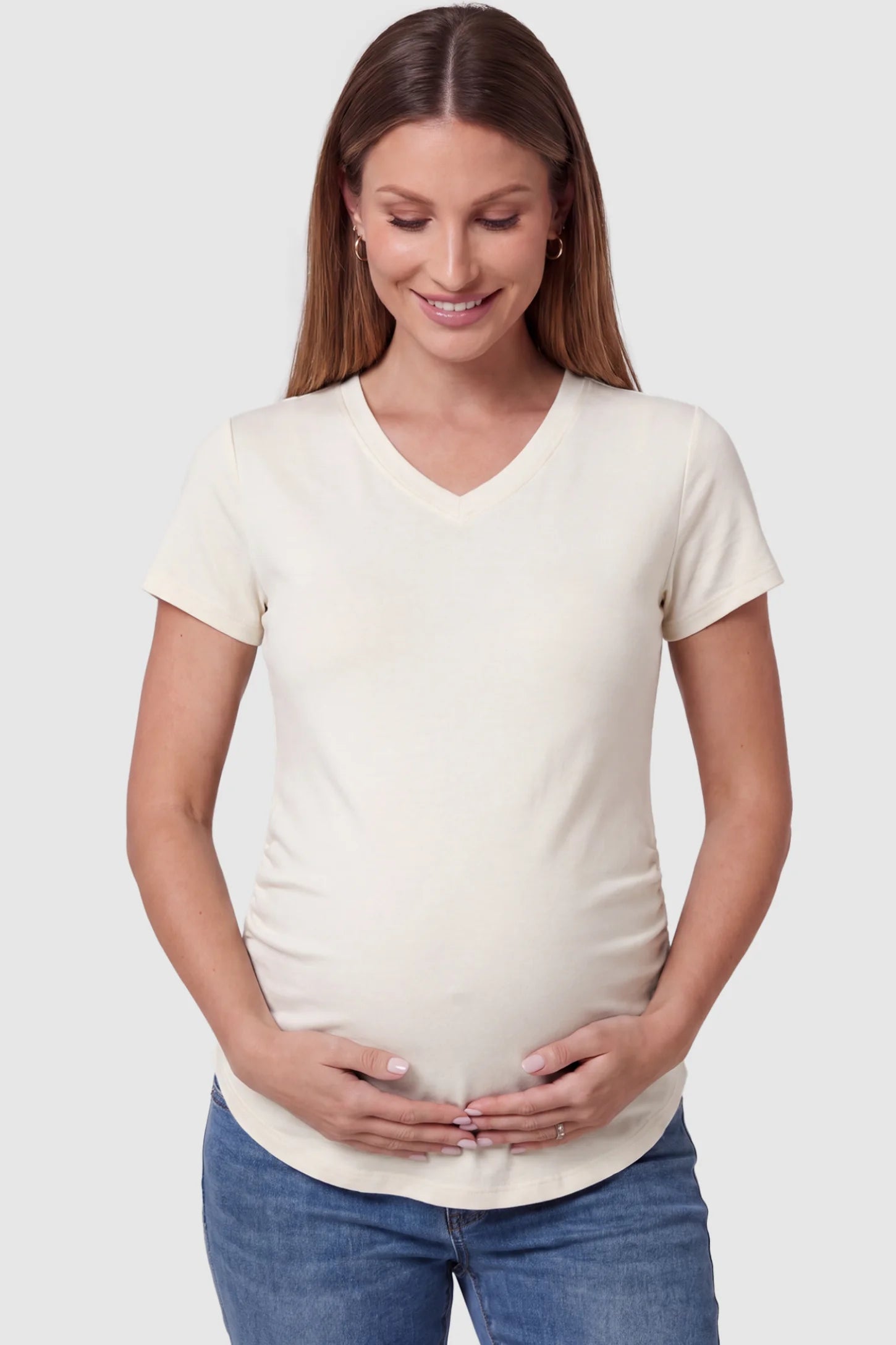 Side Ruched V-Neck Short Sleeve Maternity T-Shirt Side Ruched V-Neck Short Sleeve Maternity T-Shirt in White featuring breathable fabric and ruching on sides on a pregnant model, front view.