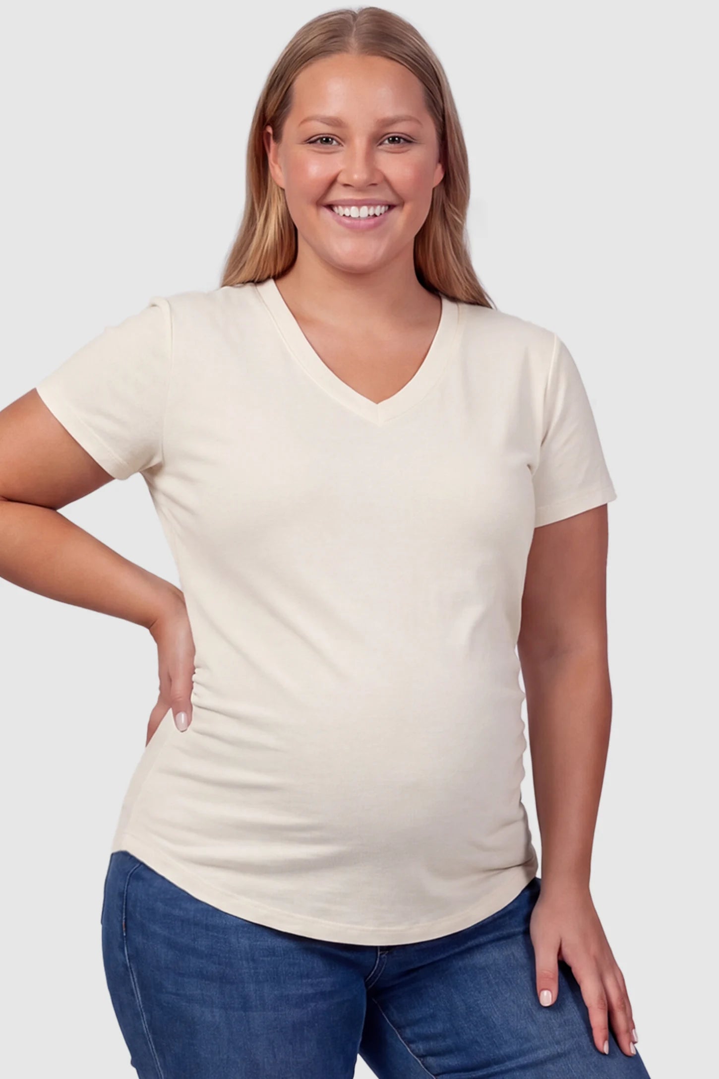 Side Ruched V-Neck Short Sleeve Maternity T-Shirt Side Ruched V-Neck Short Sleeve Maternity T-Shirt in White featuring breathable fabric and ruching on sides on a plus size pregnant model, front view.
