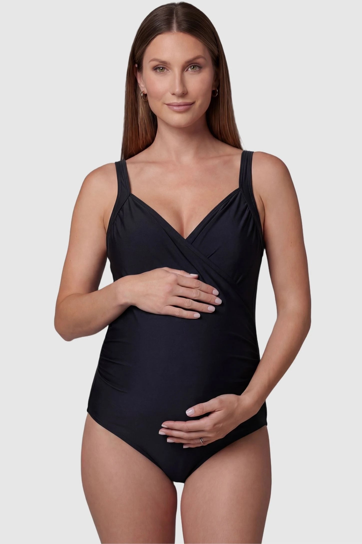 Side-Ruched Wrap-Front Maternity Swimsuit in Black with a supportive V-neckline on a pregnant model, front view.