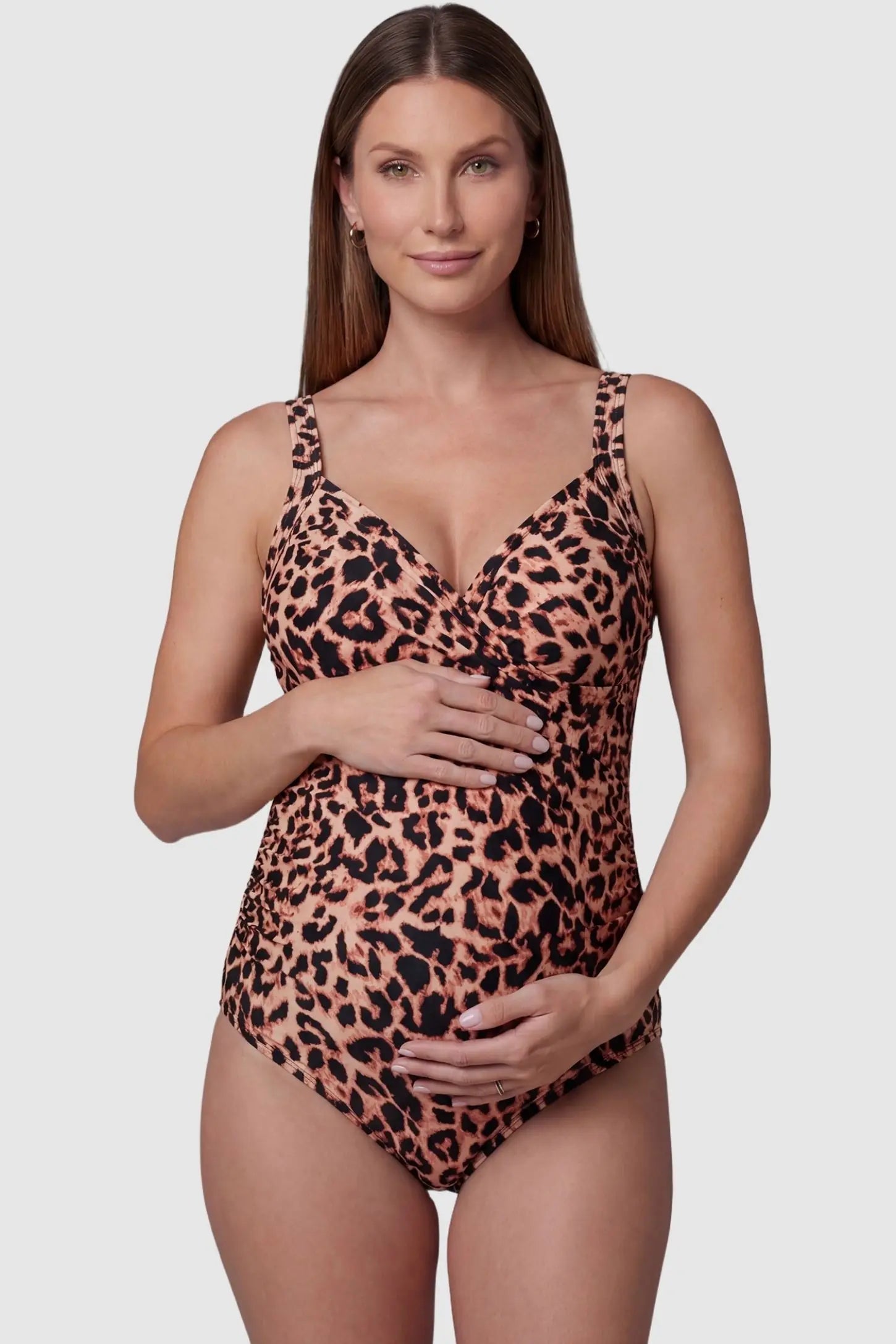 Side-Ruched Wrap-Front Maternity Swimsuit Side-Ruched Wrap-Front Maternity Swimsuit in Leopard Print with a supportive V-neckline on a pregnant model, front view.