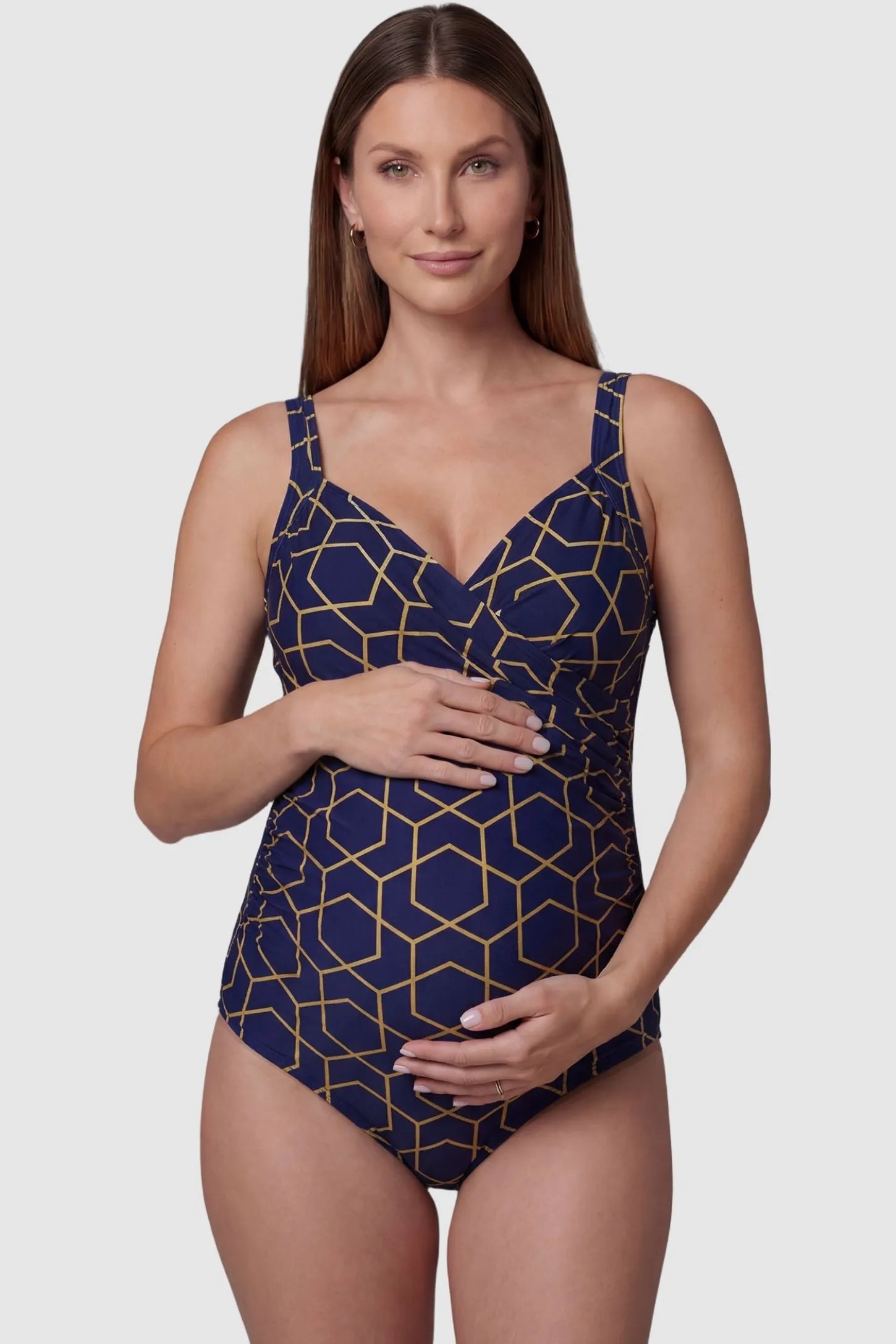 Side-Ruched Wrap-Front Maternity Swimsuit Side-Ruched Wrap-Front Maternity Swimsuit in Navy Stripe with a supportive V-neckline on a pregnant model, front view.