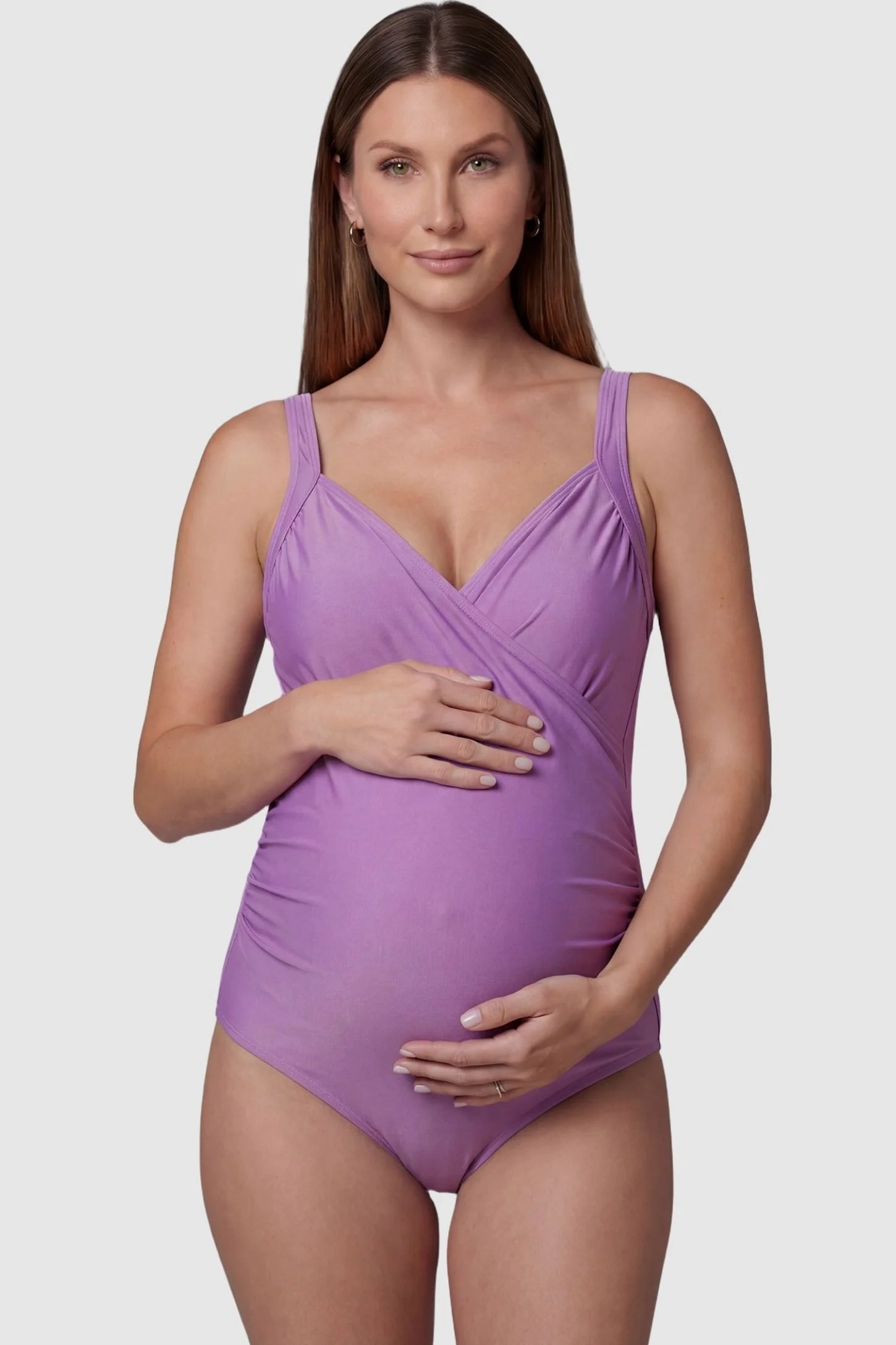 Side-Ruched Wrap-Front Maternity Swimsuit Side-Ruched Wrap-Front Maternity Swimsuit in Purple with a supportive V-neckline on a pregnant model, front view.