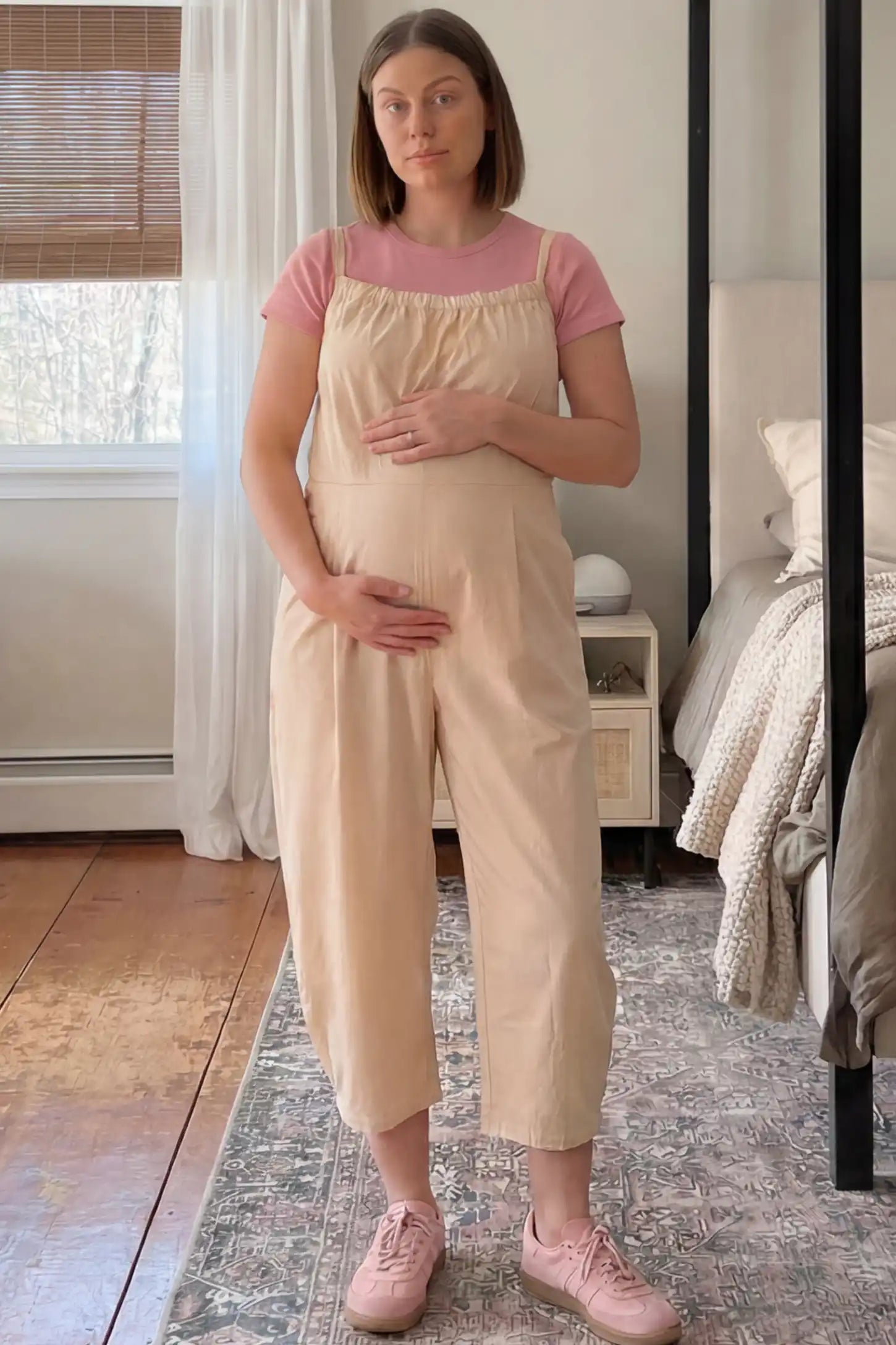 Sleeveless Balloon-Leg Maternity Jumpsuit Sleeveless Balloon-Leg Maternity Jumpsuit in Beige featuring deep side pockets on a pregnant woman in indoor setting, front view.