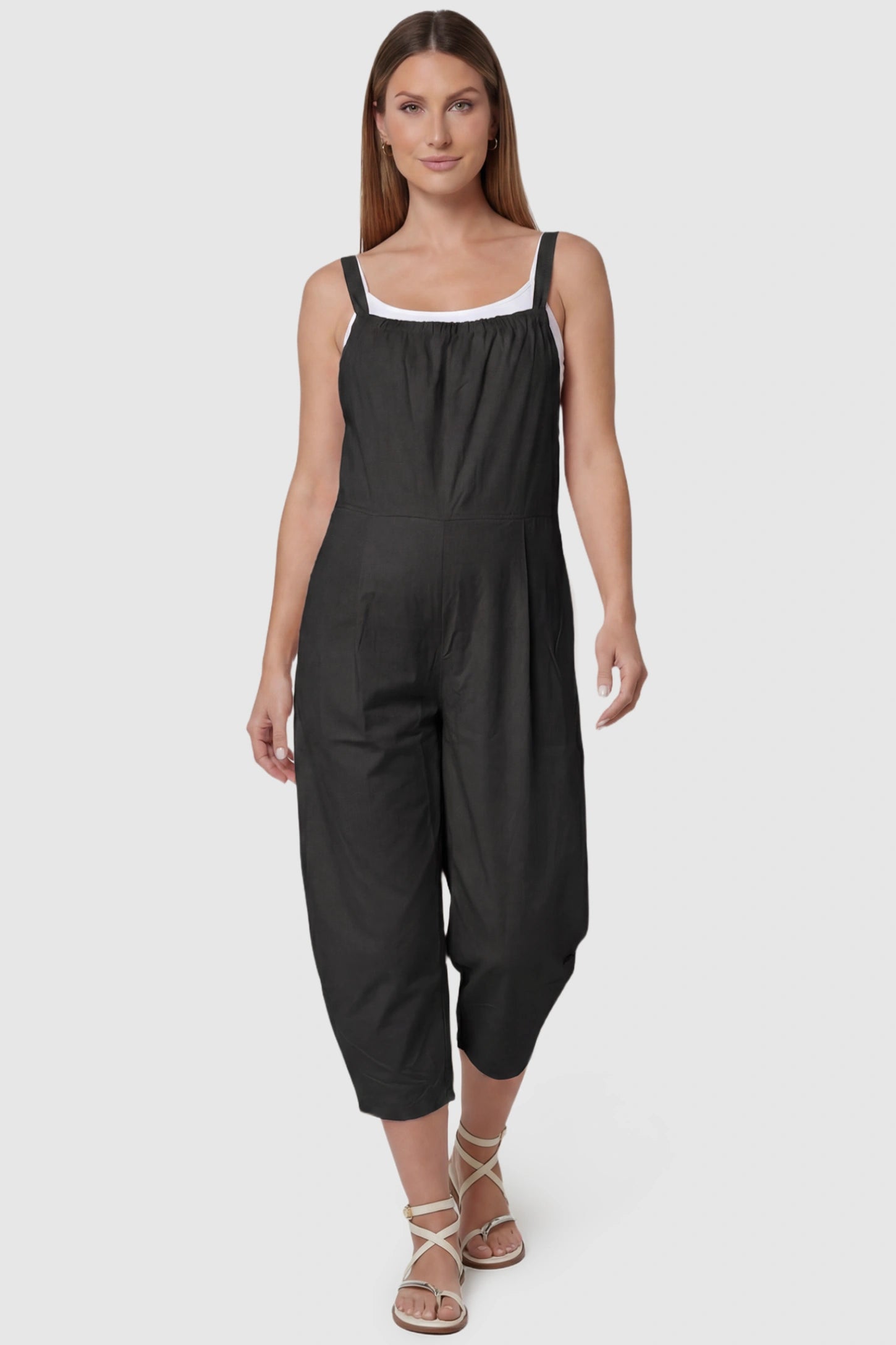 Sleeveless Balloon-Leg Maternity Jumpsuit Sleeveless Balloon-Leg Maternity Jumpsuit in Black featuring deep side pockets on a pregnant model, front view.