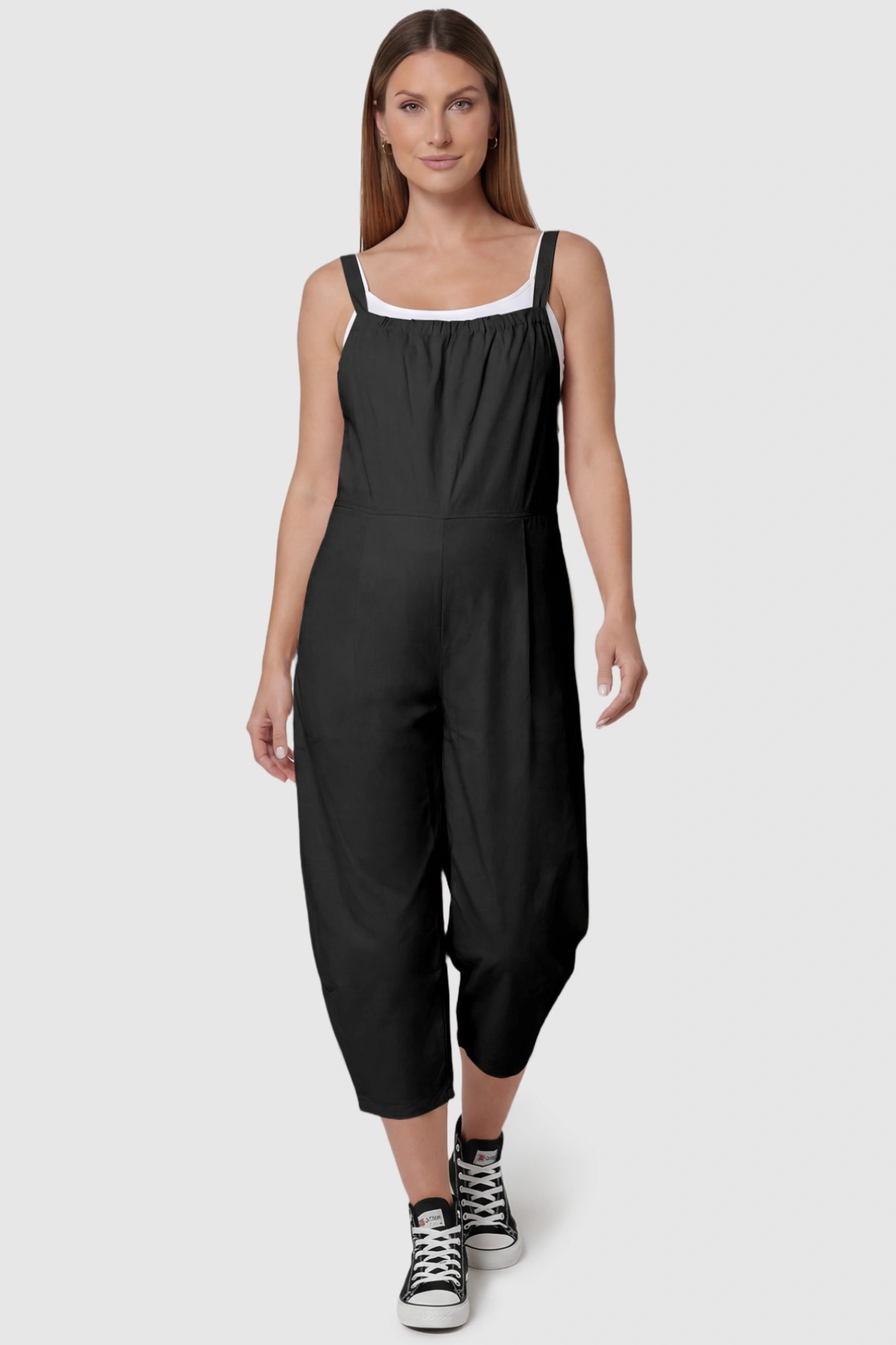 Sleeveless Balloon-Leg Maternity Jumpsuit Sleeveless Balloon-Leg Maternity Jumpsuit in Black featuring deep side pockets on a pregnant model, front view.
