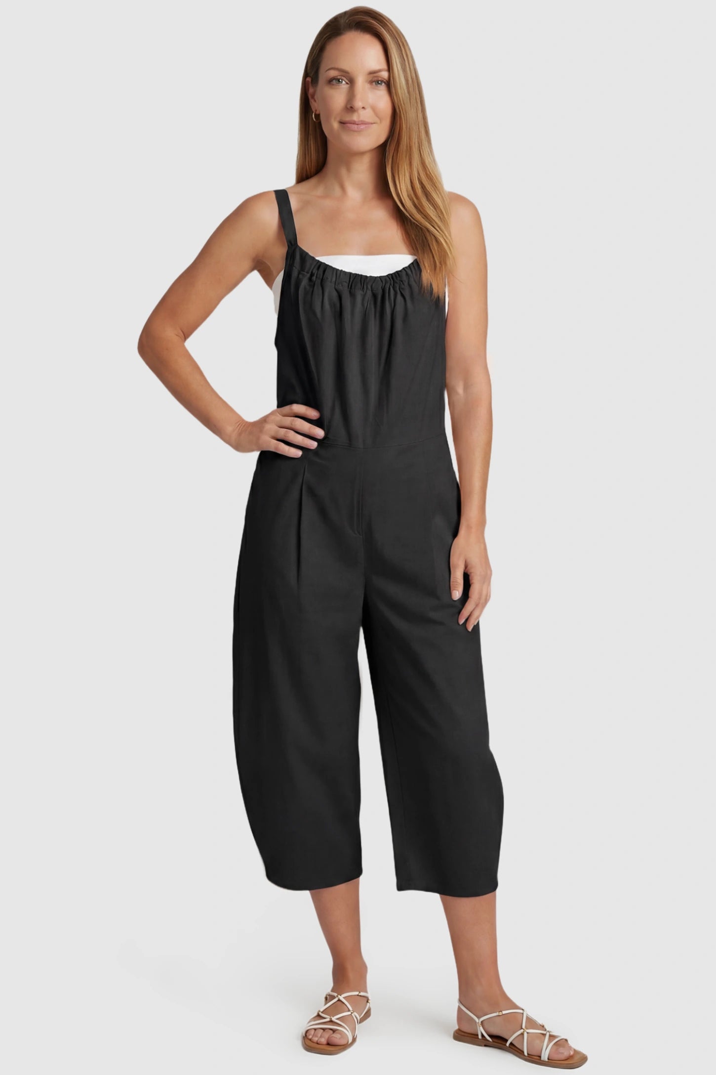 Sleeveless Balloon-Leg Maternity Jumpsuit Sleeveless Balloon-Leg Maternity Jumpsuit in Black featuring deep side pockets on a postpartum model, front view.