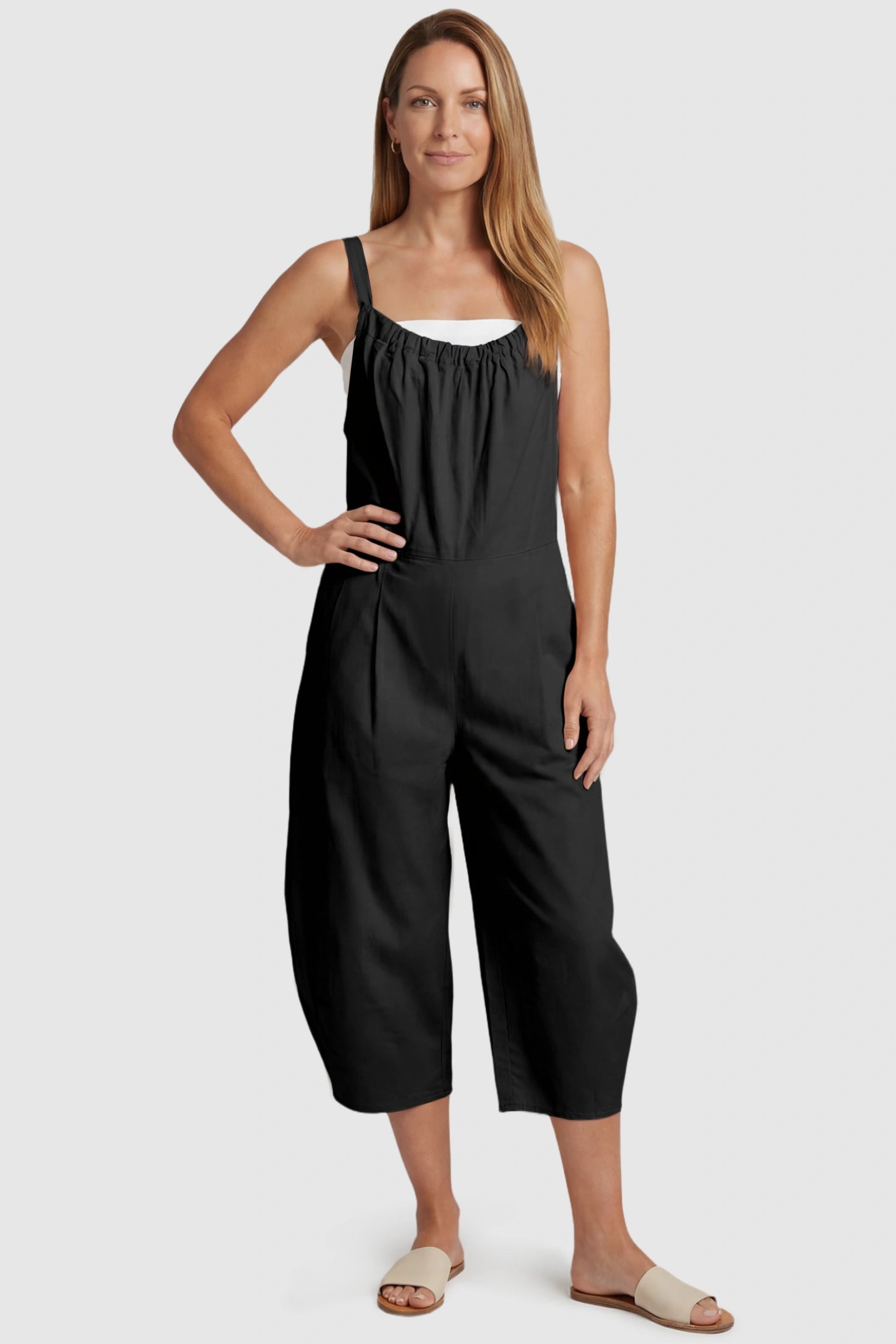 Sleeveless Balloon-Leg Maternity Jumpsuit Sleeveless Balloon-Leg Maternity Jumpsuit in Black featuring deep side pockets on a postpartum model, front view.