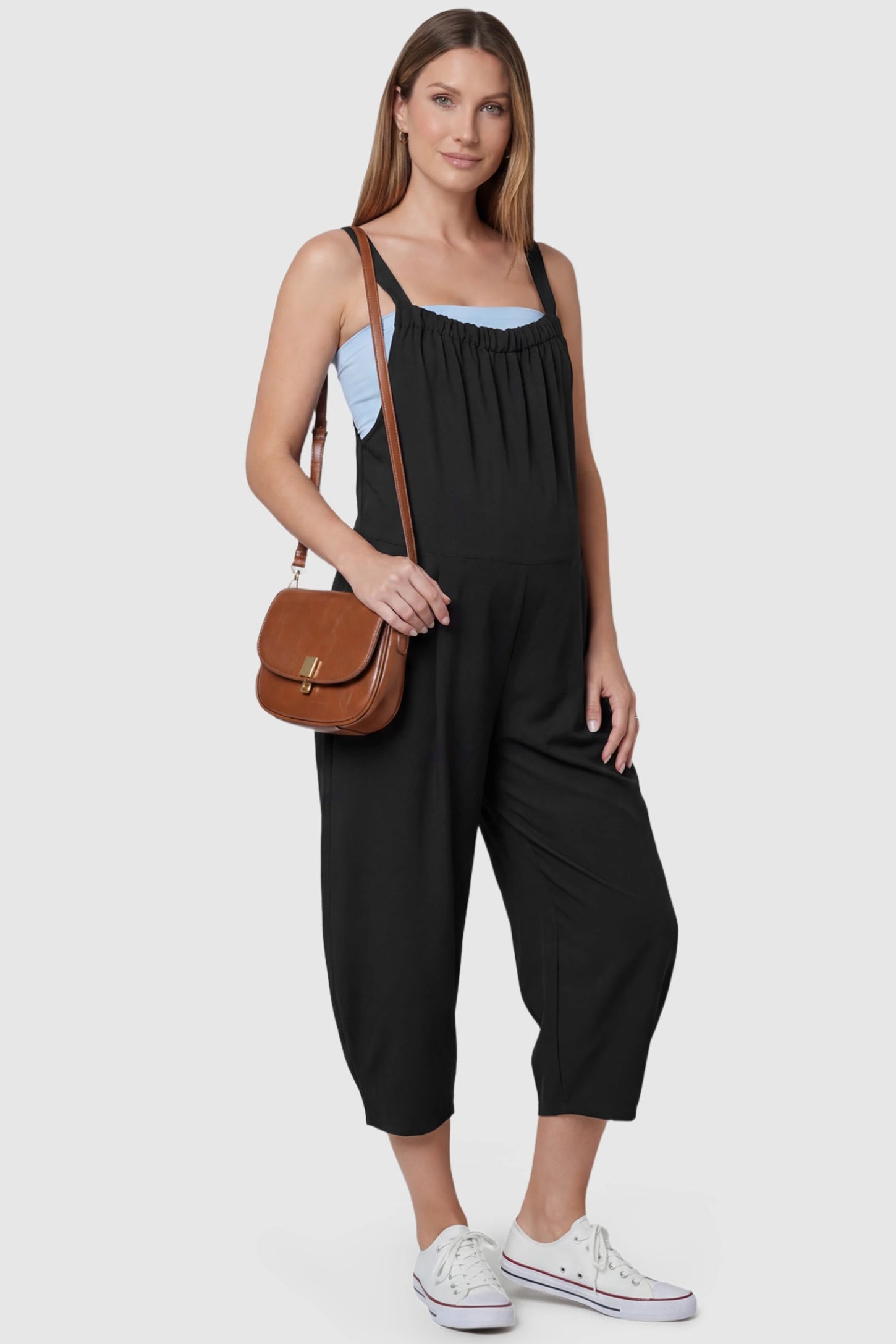 Sleeveless Balloon-Leg Maternity Jumpsuit Sleeveless Balloon-Leg Maternity Jumpsuit in Black featuring deep side pockets on a pregnant model, front view.