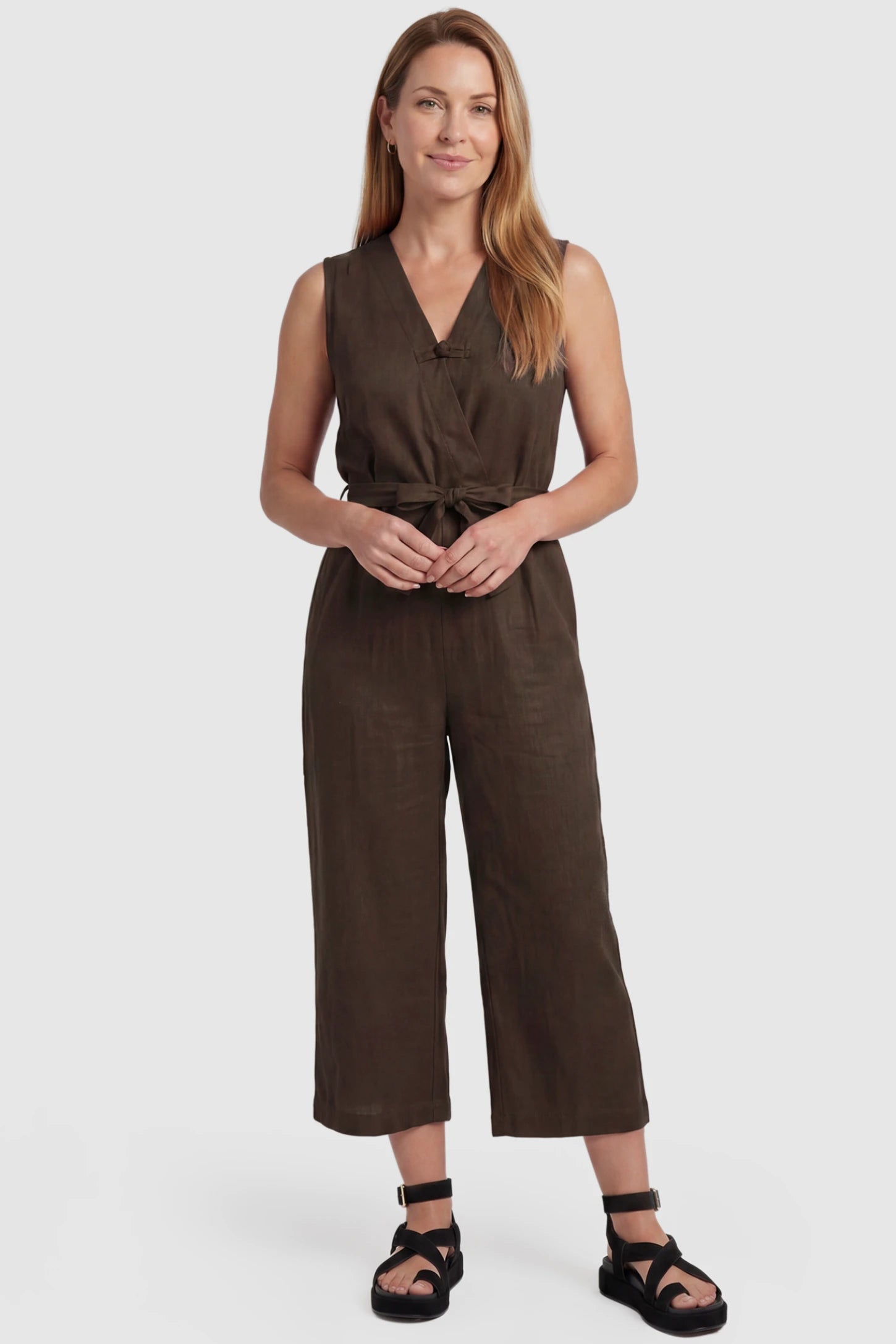 Sleeveless V-Neck Tie-Waist Maternity Jumpsuit Sleeveless V-Neck Tie-Waist Maternity Jumpsuit in Brown featuring a relaxed wide-leg design on a postpartum model, front view.