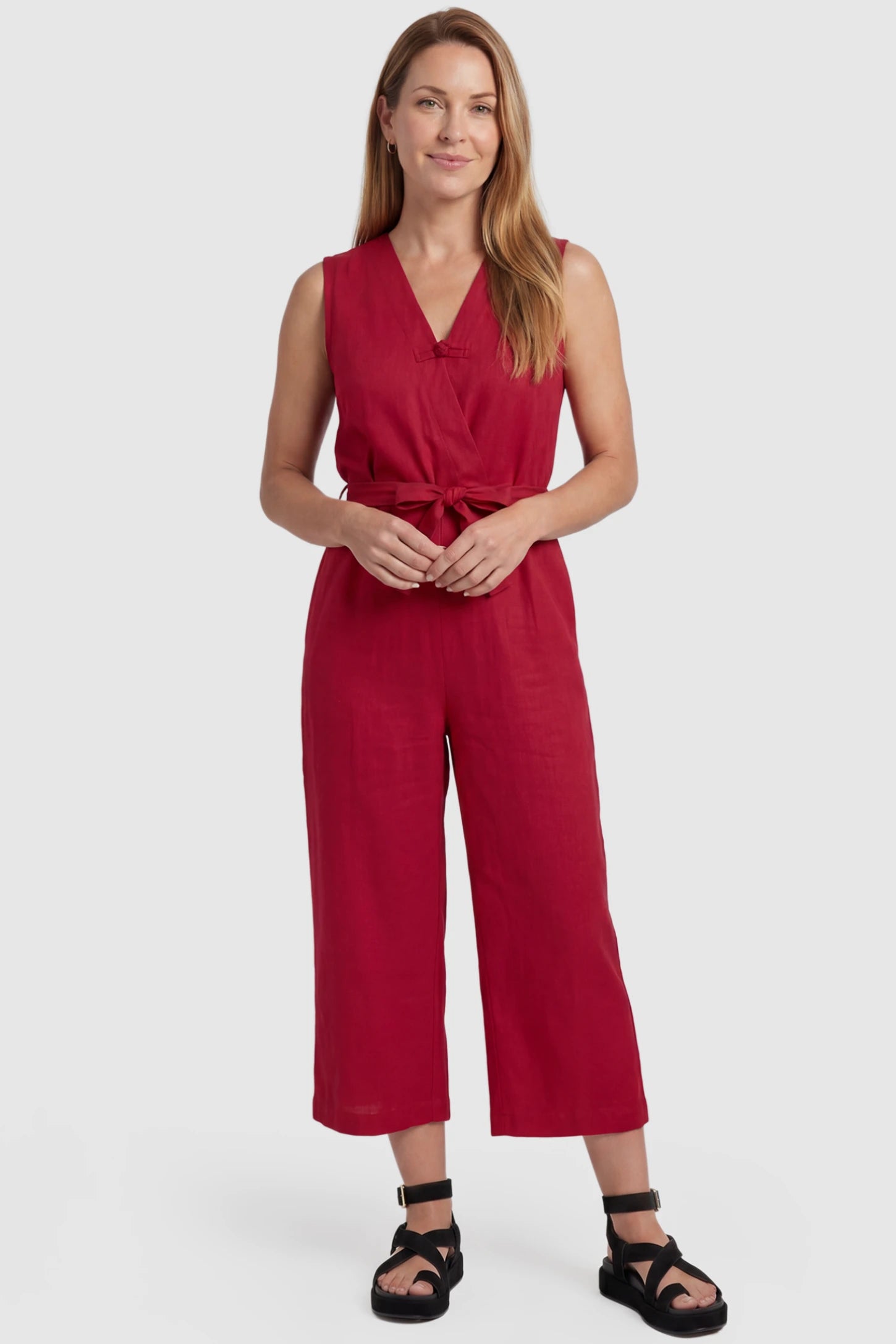 Sleeveless V-Neck Tie-Waist Maternity Jumpsuit Sleeveless V-Neck Tie-Waist Maternity Jumpsuit in Red featuring a relaxed wide-leg design on a postpartum model, front view.